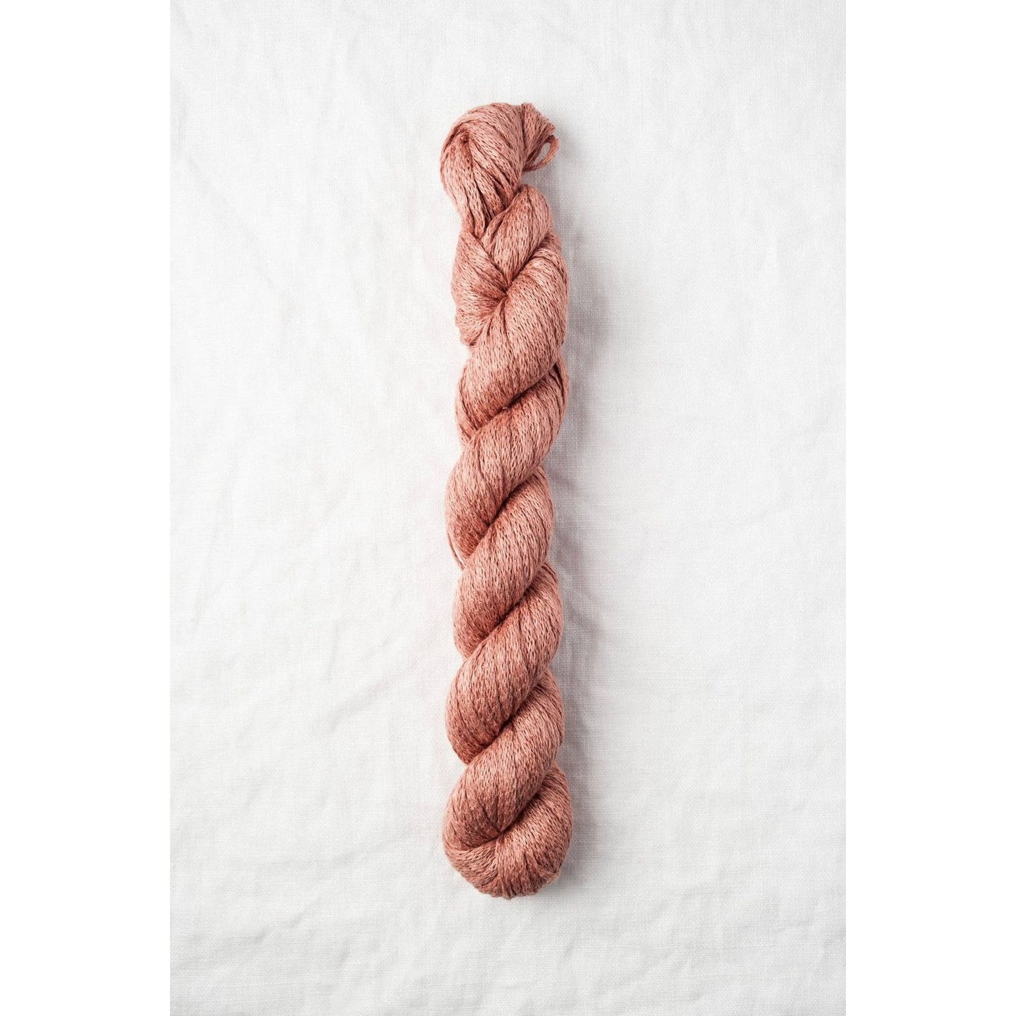 Quince & Co. organic Italian yarn in a soft peach color, ideal for knitting and crocheting projects