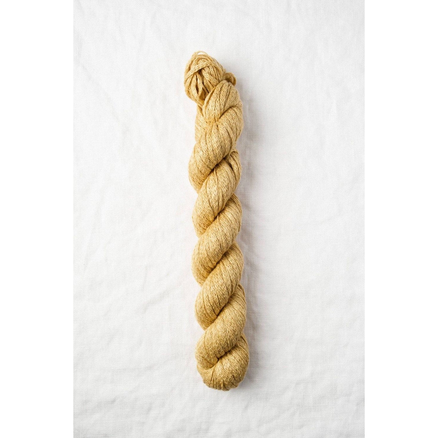 Quince & Co. Organic Italian Yarn in golden hue, perfect for eco-friendly knitting projects