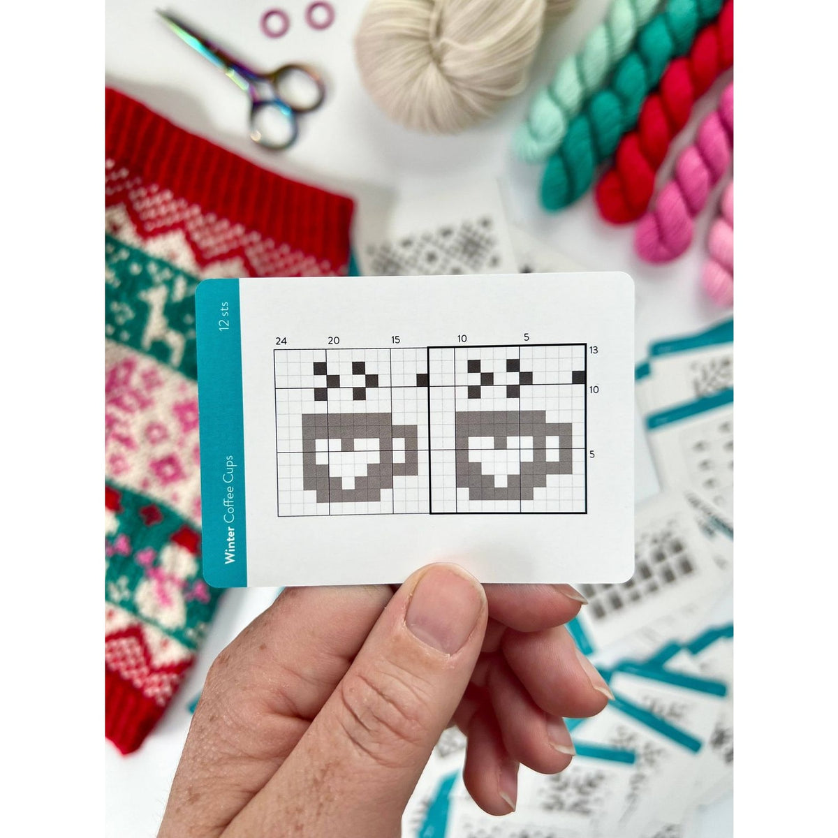 Craft patterns displayed on a card from a deck of card for winter-themed knitting projects