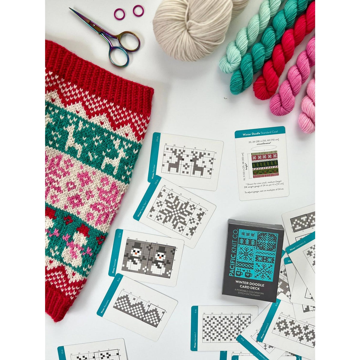 Creative crafting scene with knitting, yarn, and a deck of card featuring unique designs for inspiration