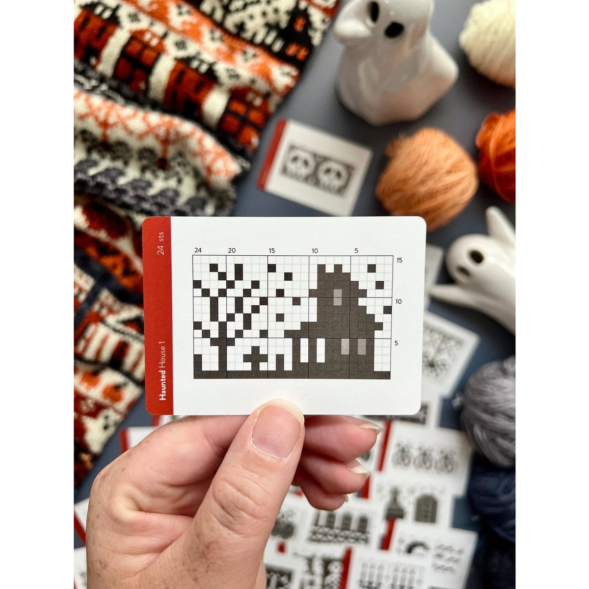 Hand holding a Twice Sheared Sheep deck of card featuring a pixel art design for crafting