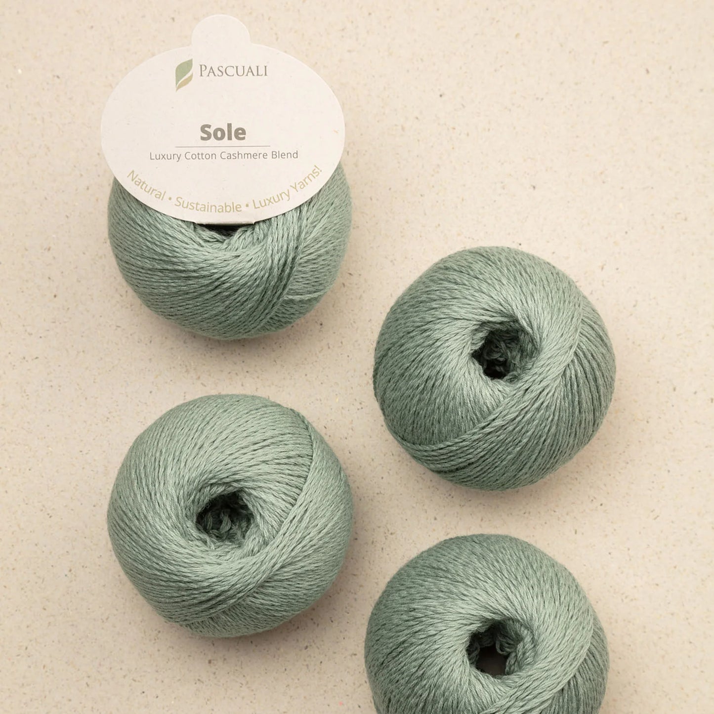 Pascuali Sole Systems luxury cotton cashmere blend yarn in soft green color, perfect for delicate projects