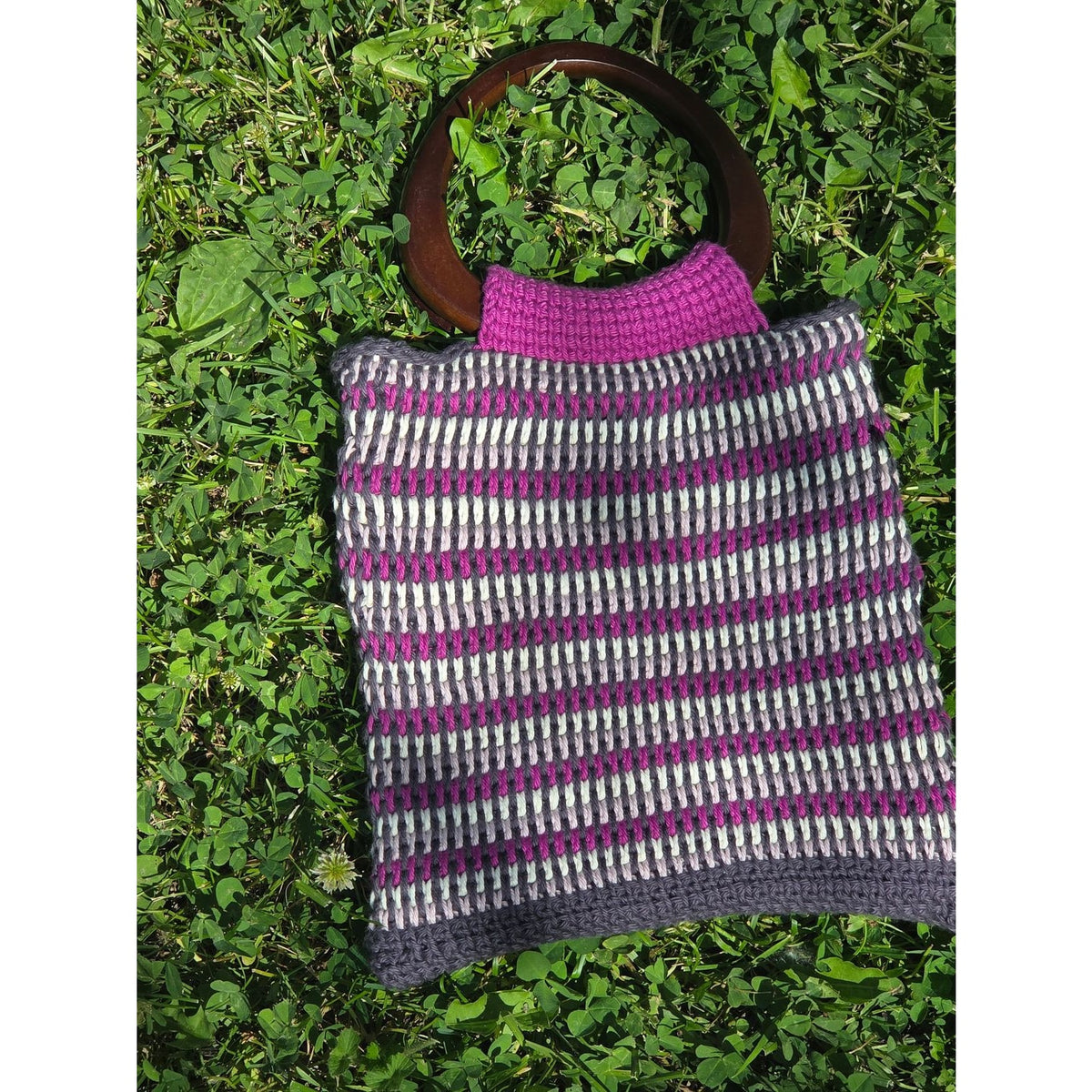Handmade bag with wooden handles, featuring colorful patterns for making a bag from AriYARN Shop and Studio