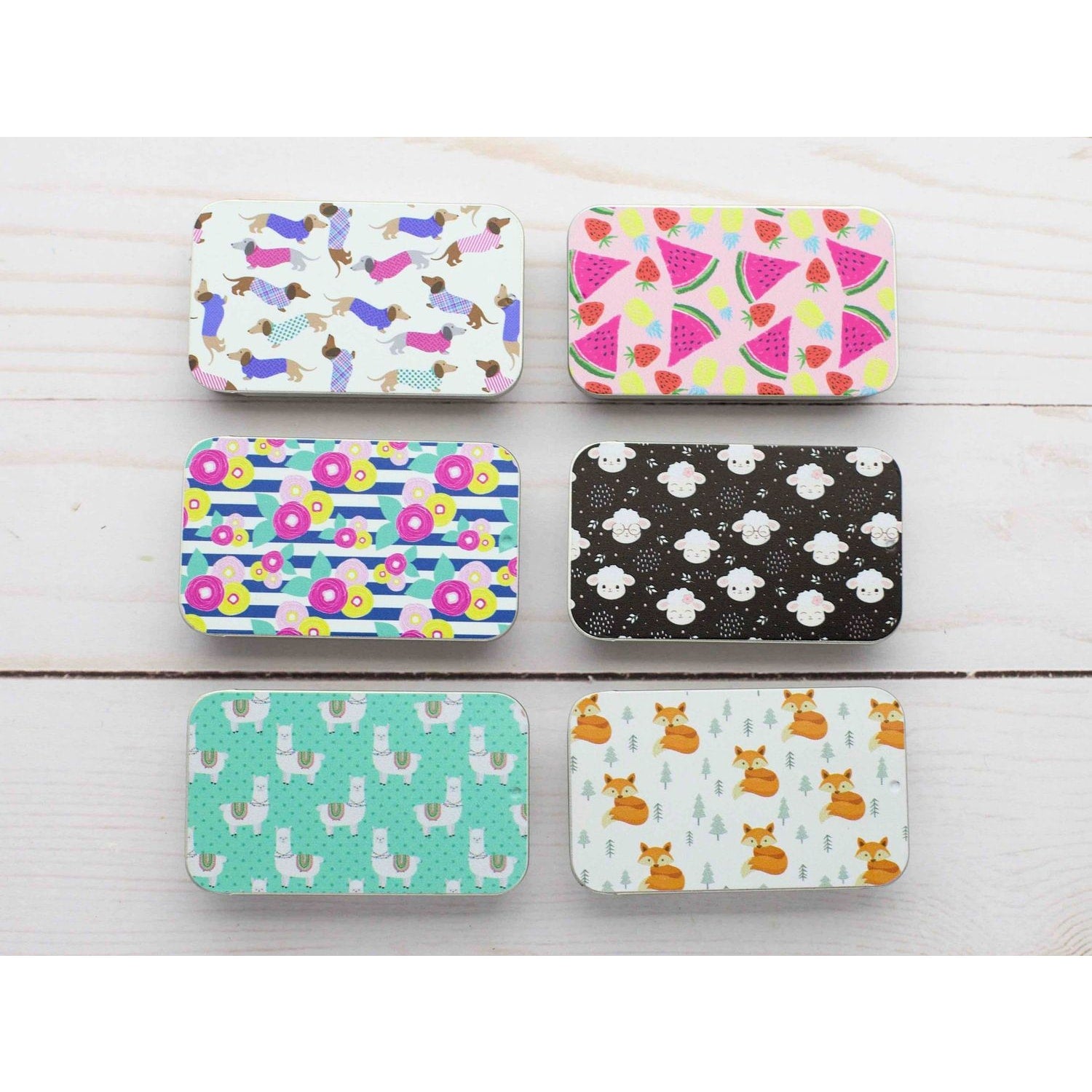 Colorful print slide top storage tins featuring various fun patterns including animals and fruits