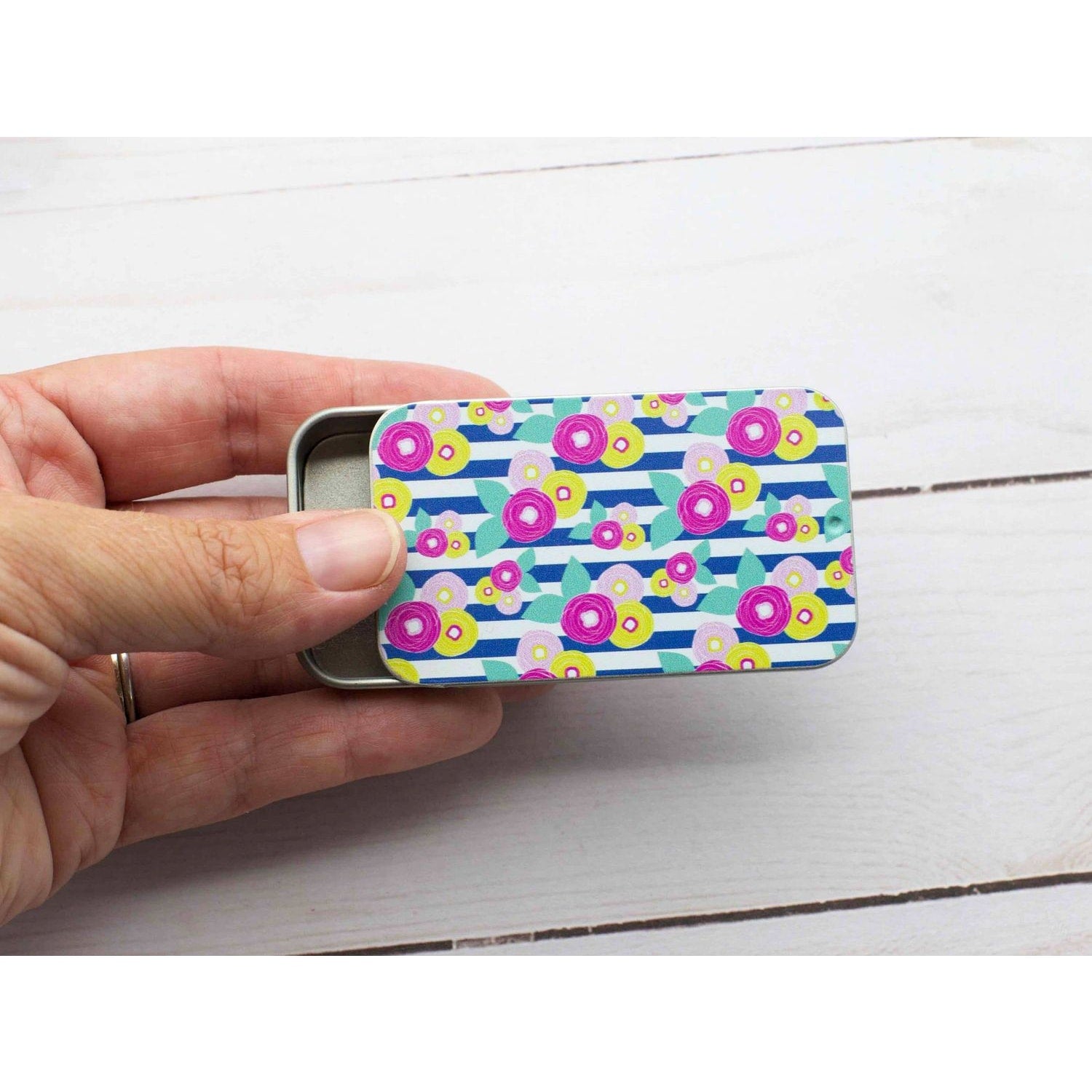 Colorful print slide top storage tins featuring vibrant floral design, perfect for craft supplies