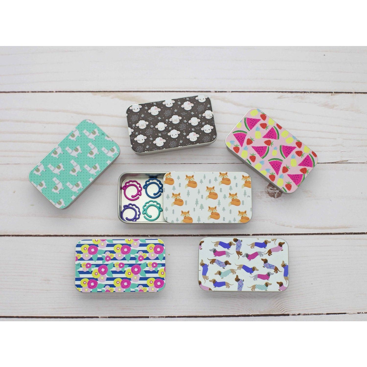 Colorful print slide top storage tins in assorted designs for organizing small items