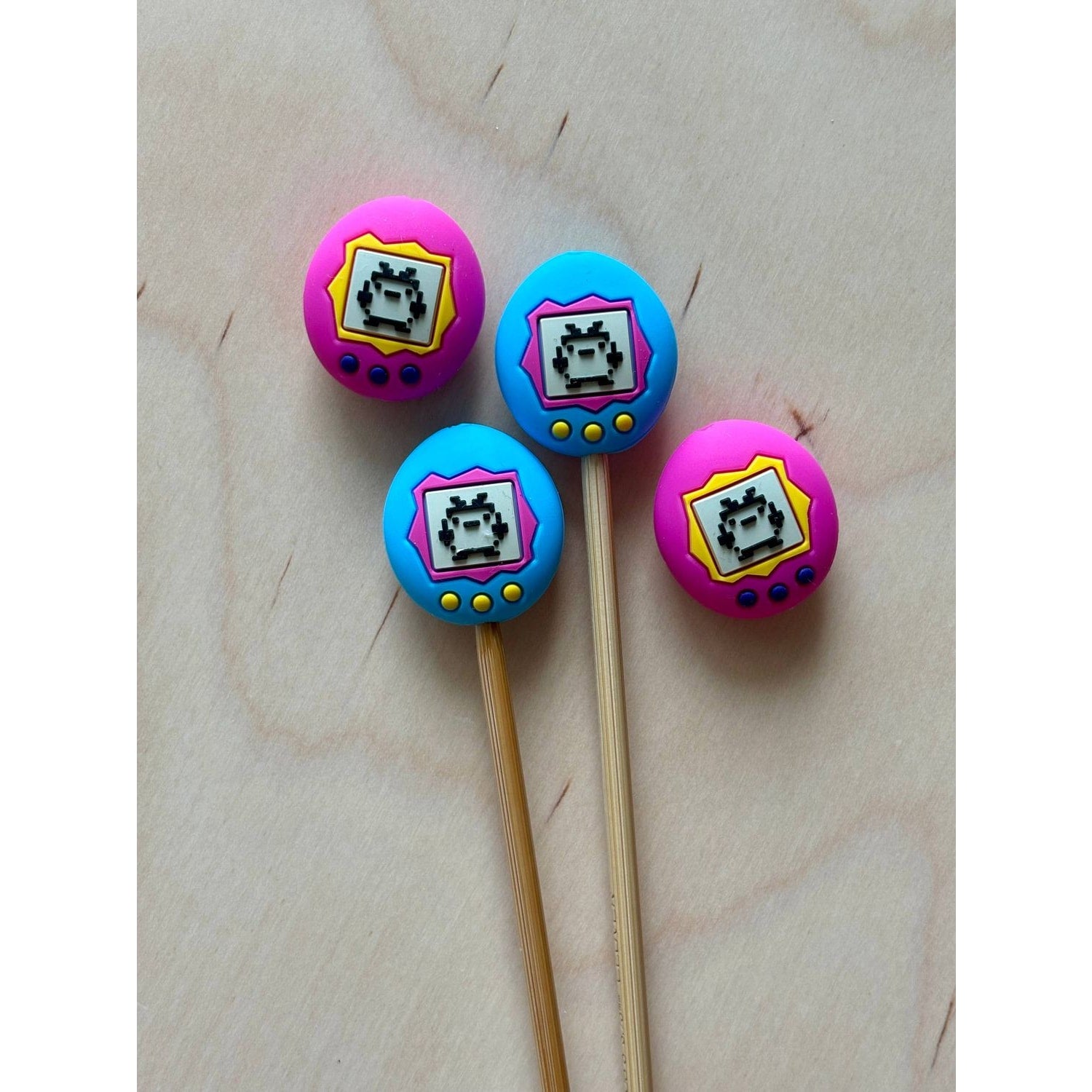 Retro video game store themed cake toppers in vibrant colors featuring pixel art designs