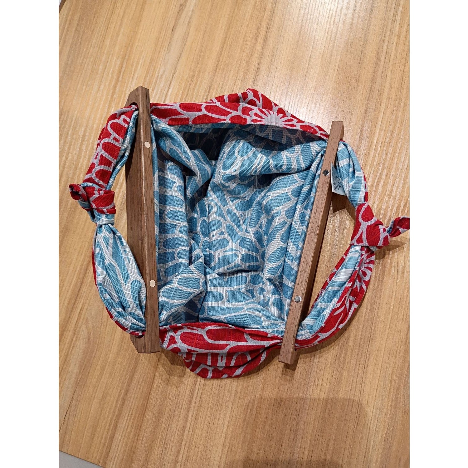 AriYARN reusable shopping bag features a colorful floral pattern and wooden handles for easy carrying
