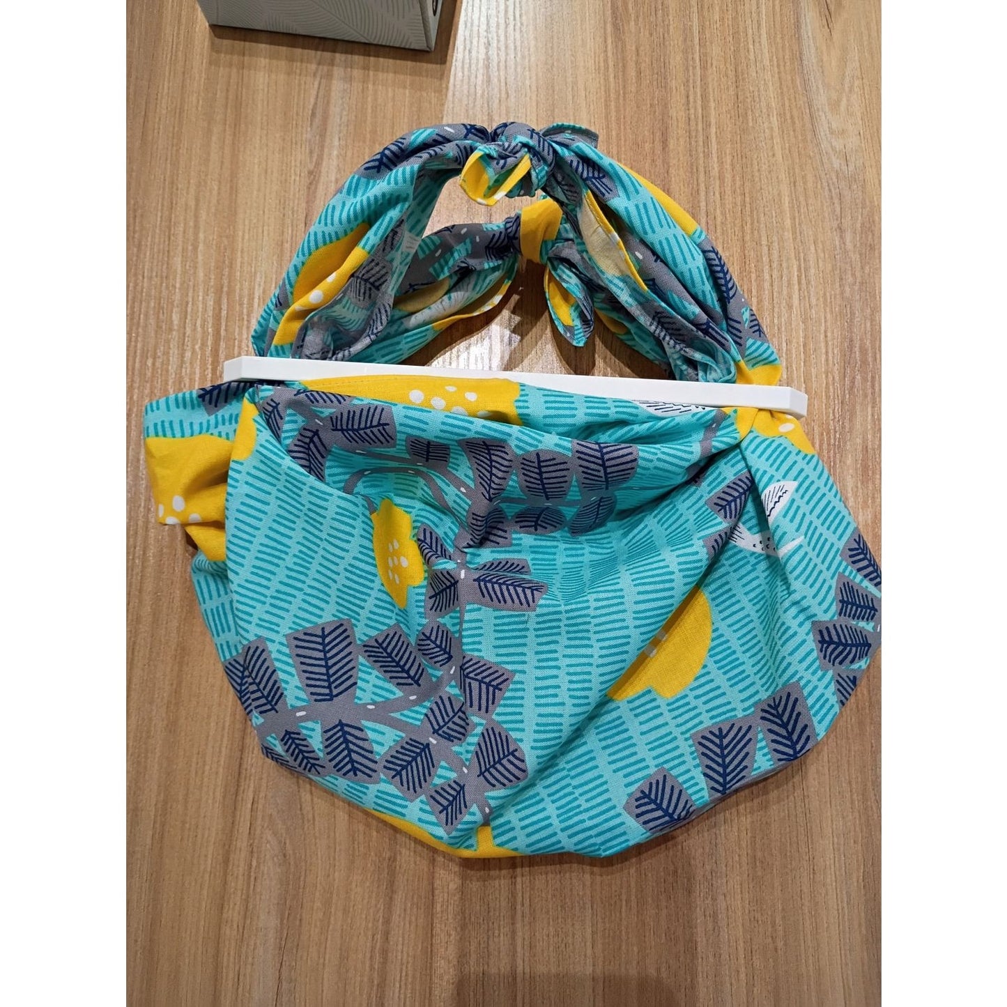 Colorful reusable shopping bag from AriYARN Shop and Studio featuring a leafy design and convenient ties