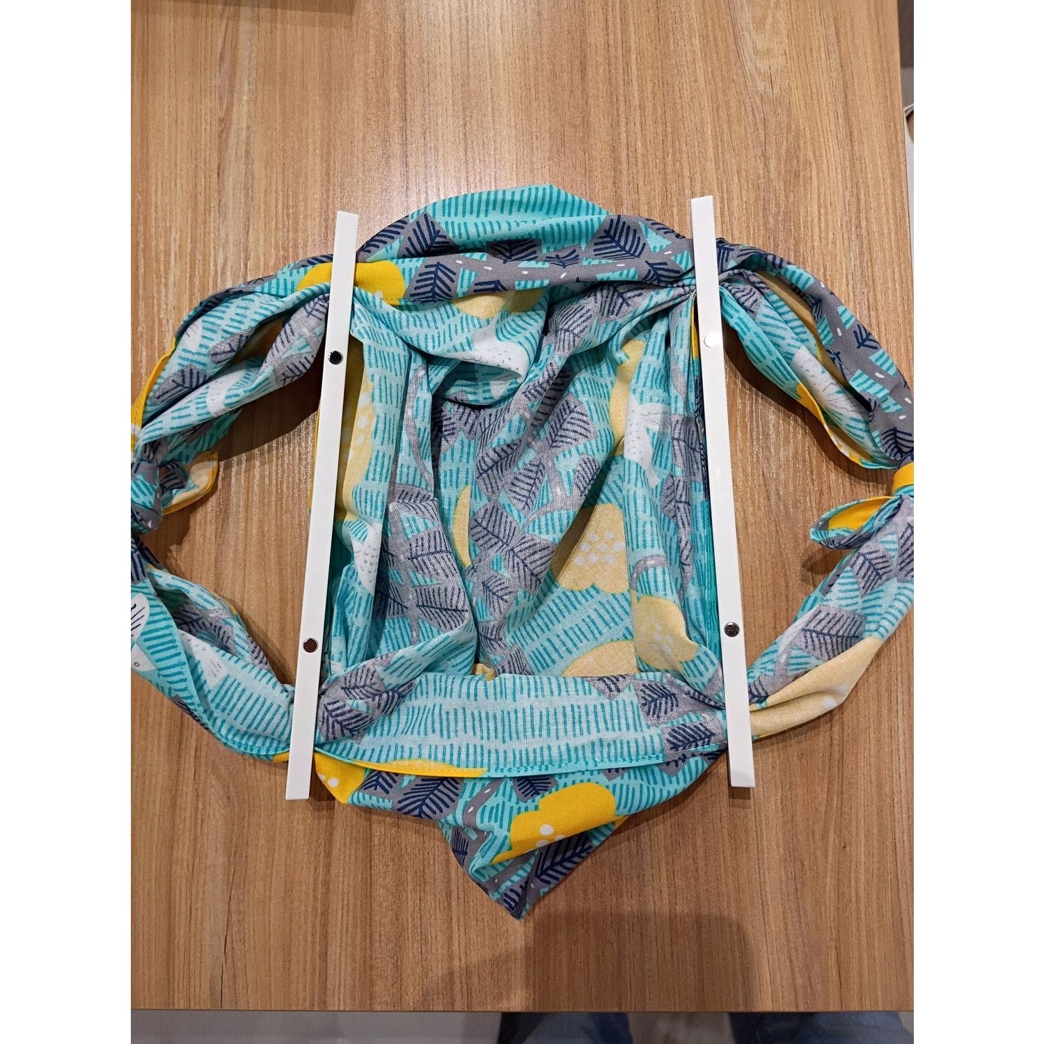 AriYARN reusable shopping bag displayed on a wooden table, featuring vibrant patterns and a unique design.