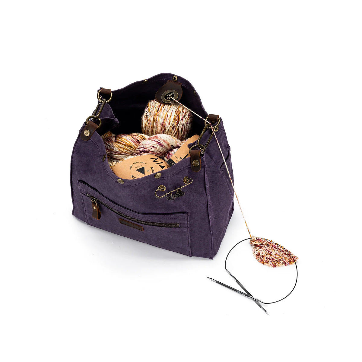 Madelinetosh rucksack backpack canvas in purple filled with yarn and knitting supplies