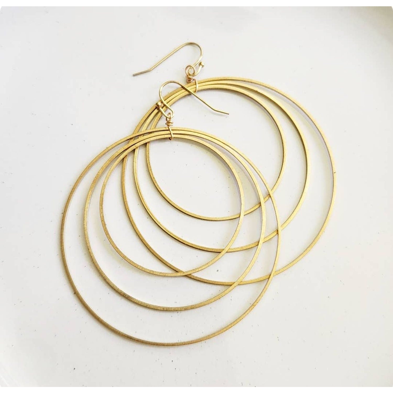 Sara Sela Jewelry brass circle hoop dangle earrings pair of layered thin concentric gold hoops with fishhook wires