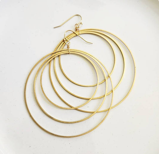 Sara Sela Jewelry brass circle hoop dangle earrings pair of layered thin concentric gold hoops with fishhook wires