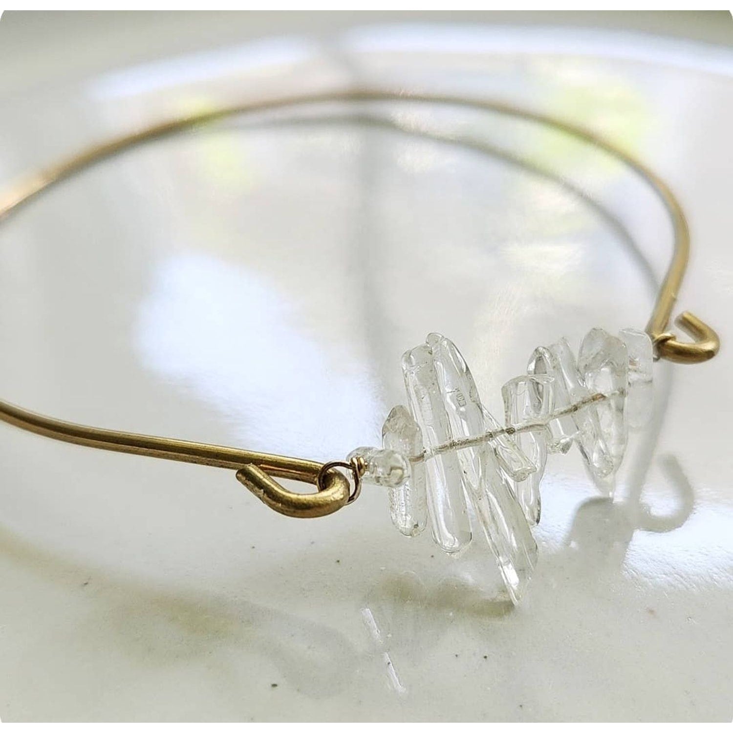 Sara Sela Jewelry gold wire clear quartz bangle bracelet with stacked raw quartz chip centerpiece and hook clasp