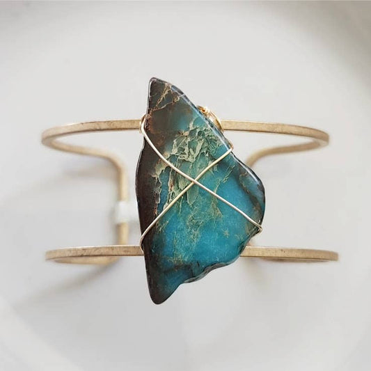 sea blue magnesite cuff bracelet by Sara Sela Jewelry with raw blue green stone wrapped in gold wire on double band