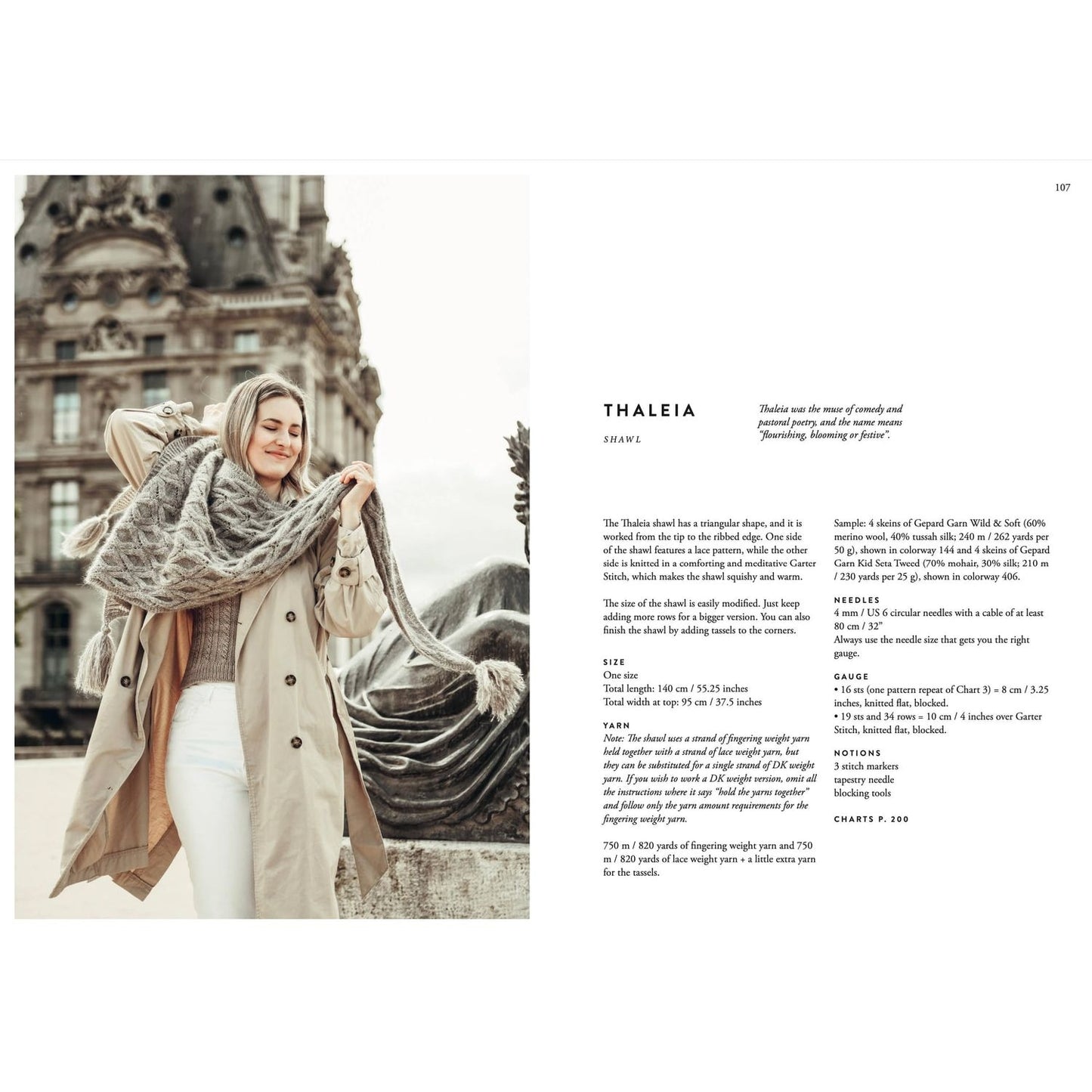 Woman in a coat showcasing a large gray knitted shawl with detailed patterns in knitting