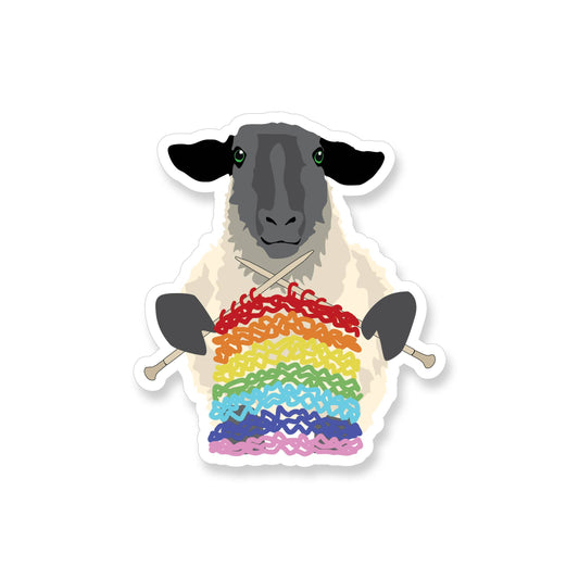Sheep knitting sticker featuring a black-faced sheep holding knitting needles with a rainbow yarn design