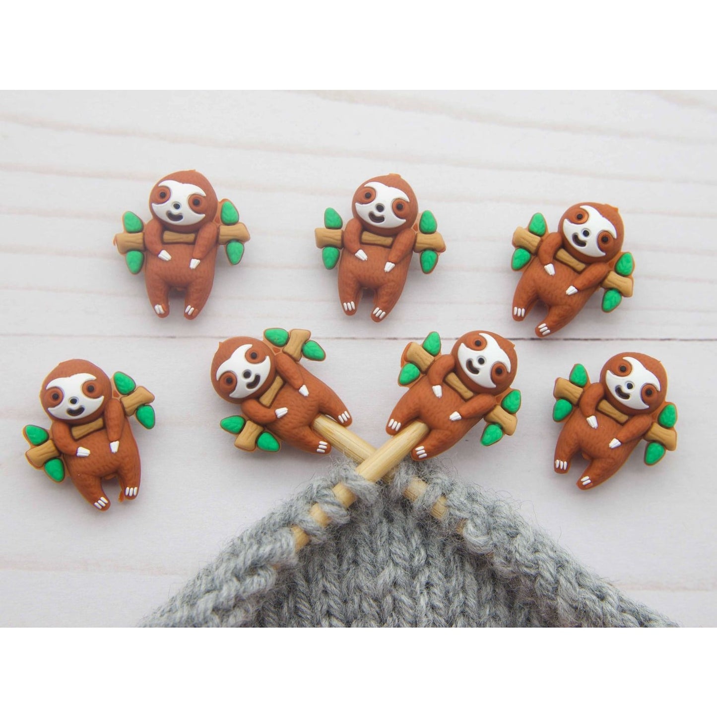 Set of Fox & Pine Stitches sid sloth stitch markers featuring cute sloth designs on wooden branches