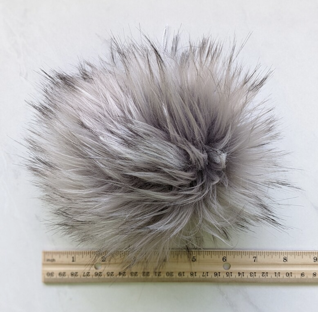 Soft silver grey pom pom for knitting with fluffy texture for creative projects
