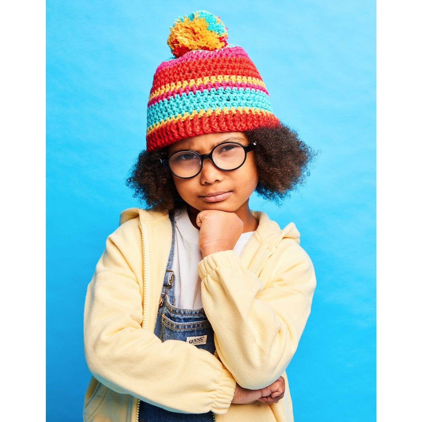 DMC kit a crochet for colorful beanie hat featuring a pom-pom and striped design for kids