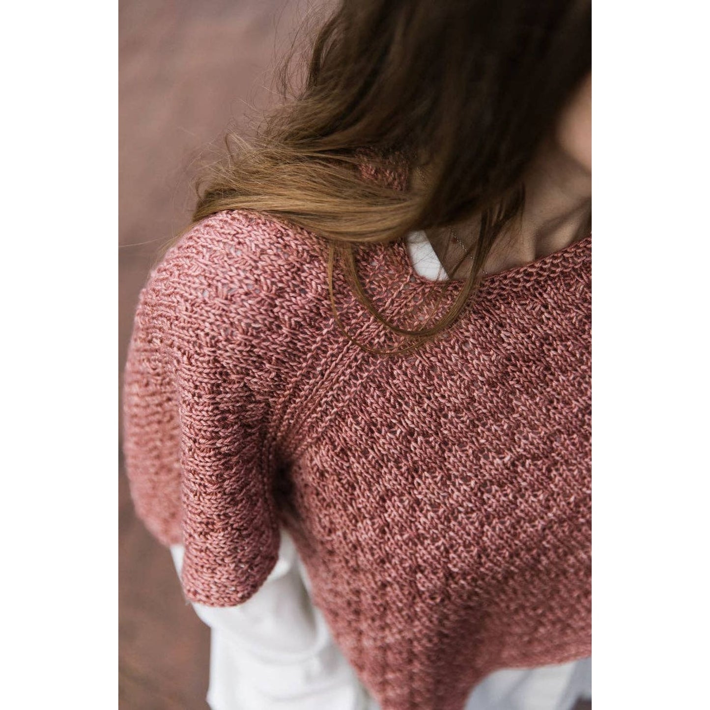 Close-up of a knitted garment in a soft pink hue inspired by the Soothing Stitches knitting book