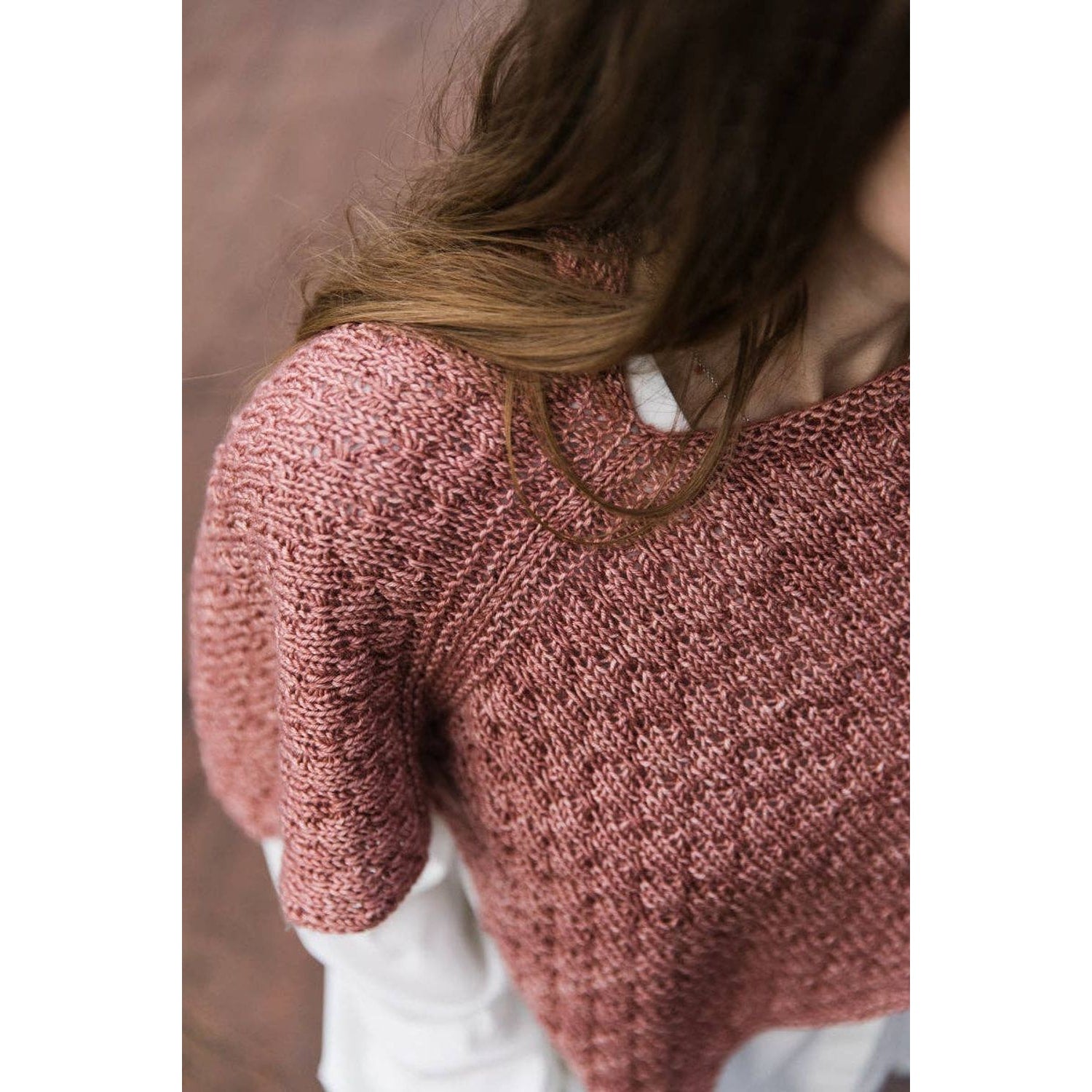 Close-up of a knitted garment in a soft pink hue inspired by the Soothing Stitches knitting book