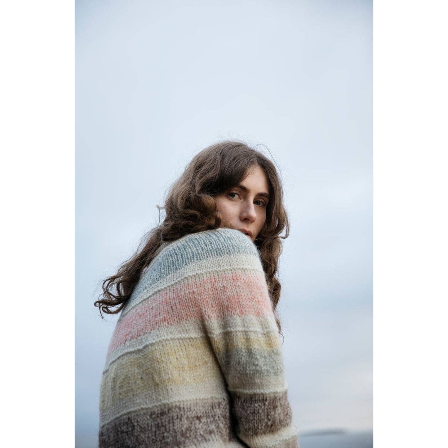 Model wearing a cozy knitted sweater from the Soothing Stitches knitting book by Laine Publishing