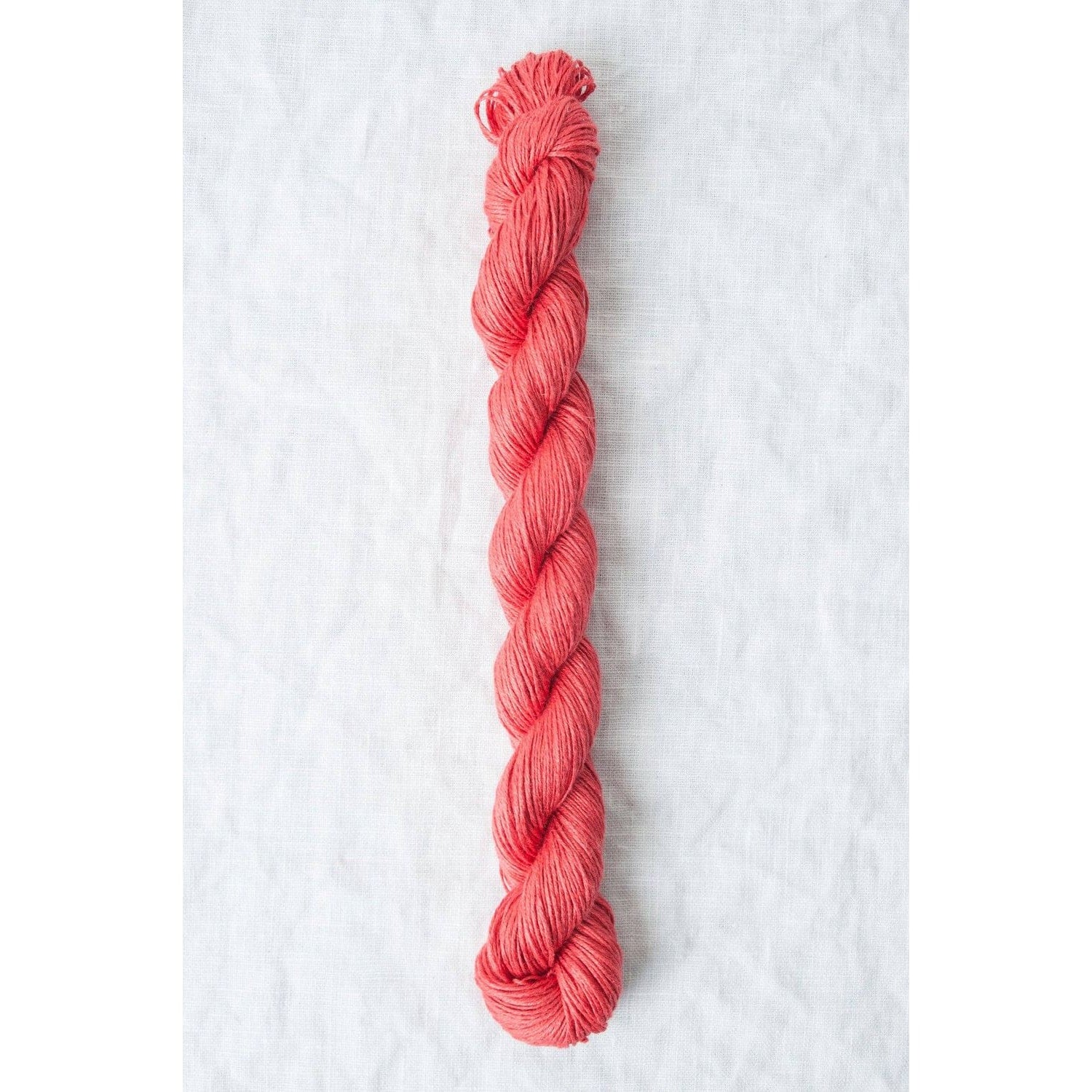 Quince & Co. Sparrow organic linen yarn in a vibrant coral color for knitting and crocheting projects