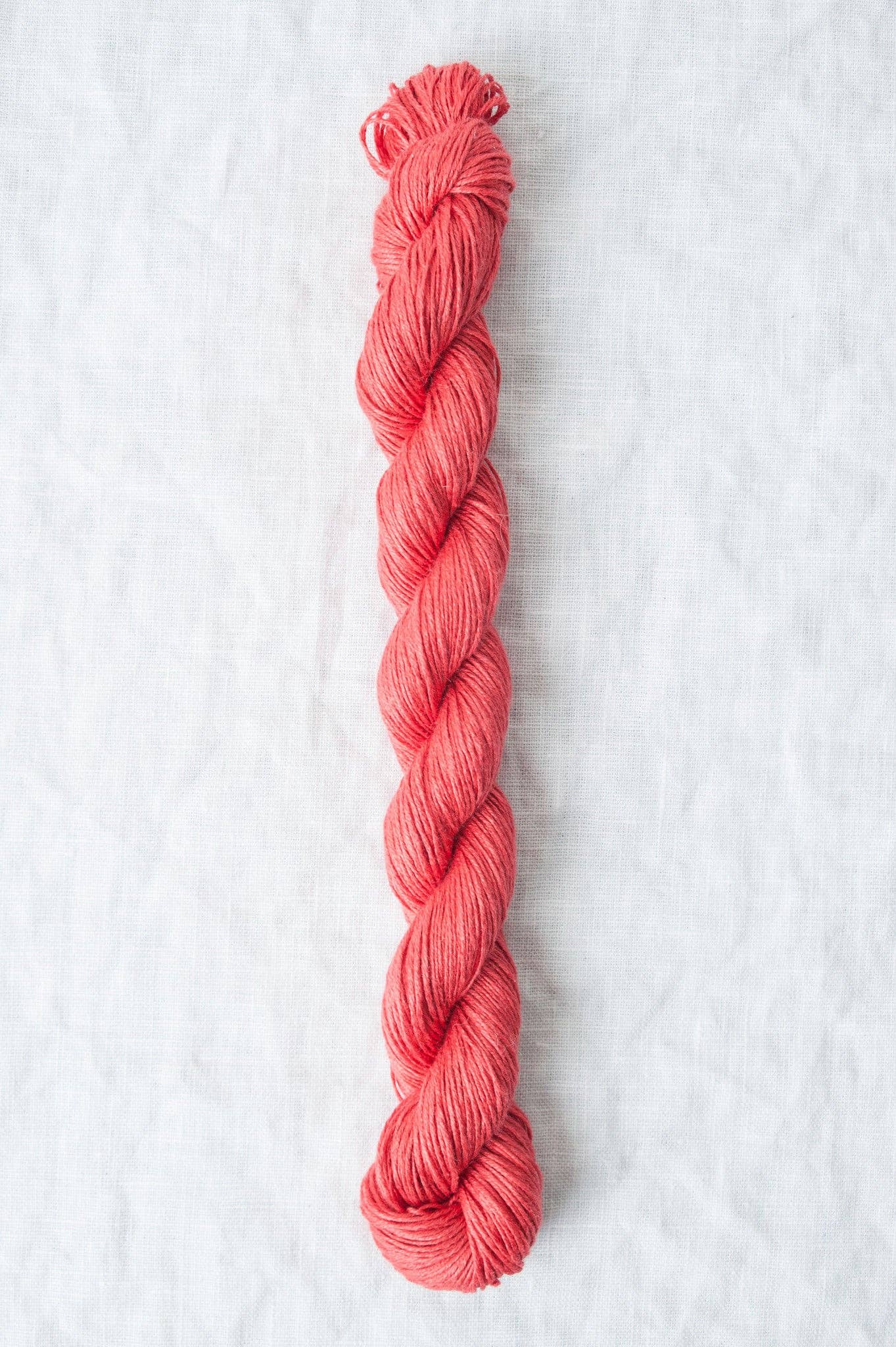 Quince & Co. Sparrow organic linen yarn in a vibrant coral color for knitting and crocheting projects