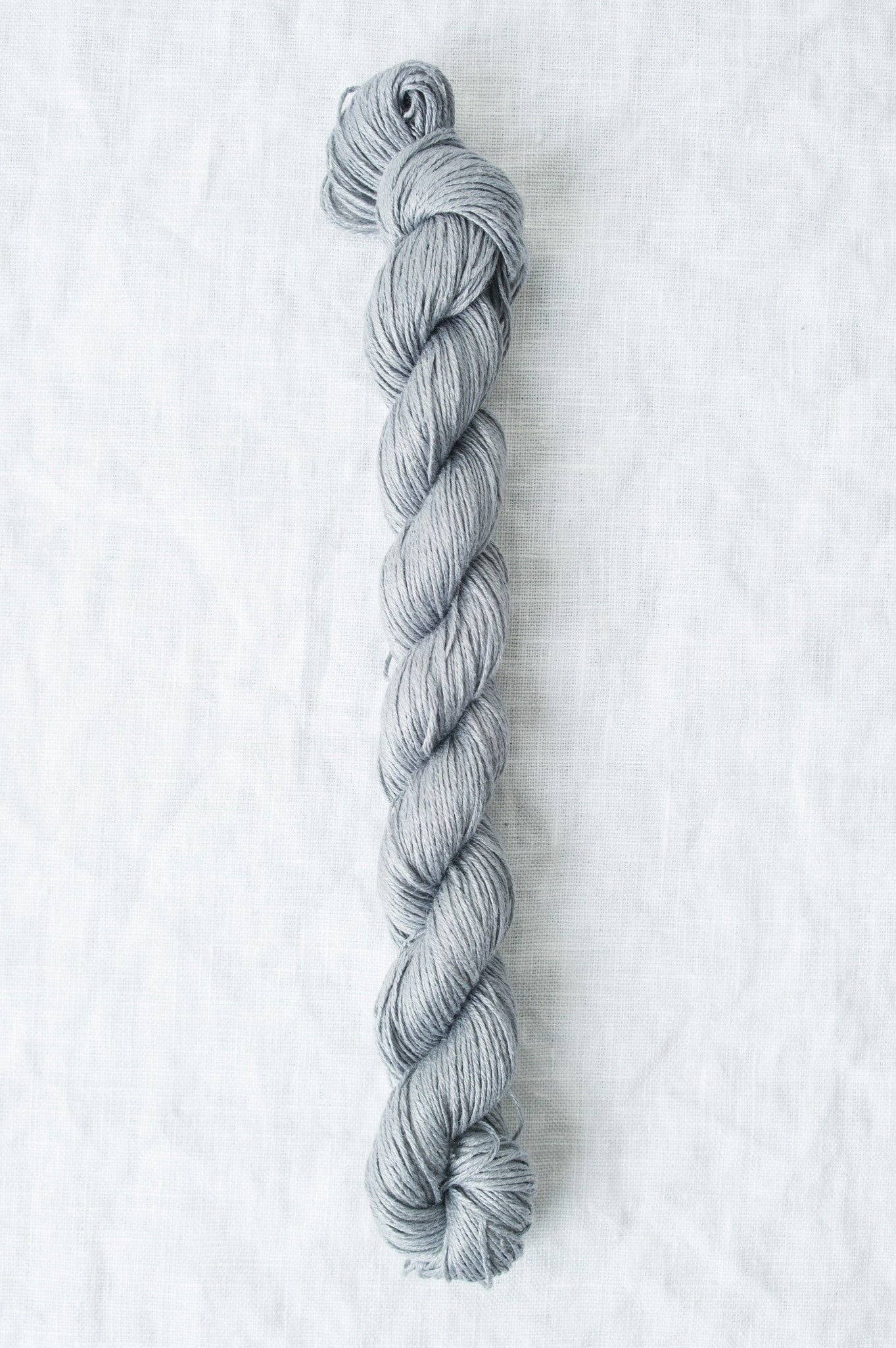 Sleek gray Sparrow organic linen yarn from Quince & Co, ideal for knitting and crochet projects