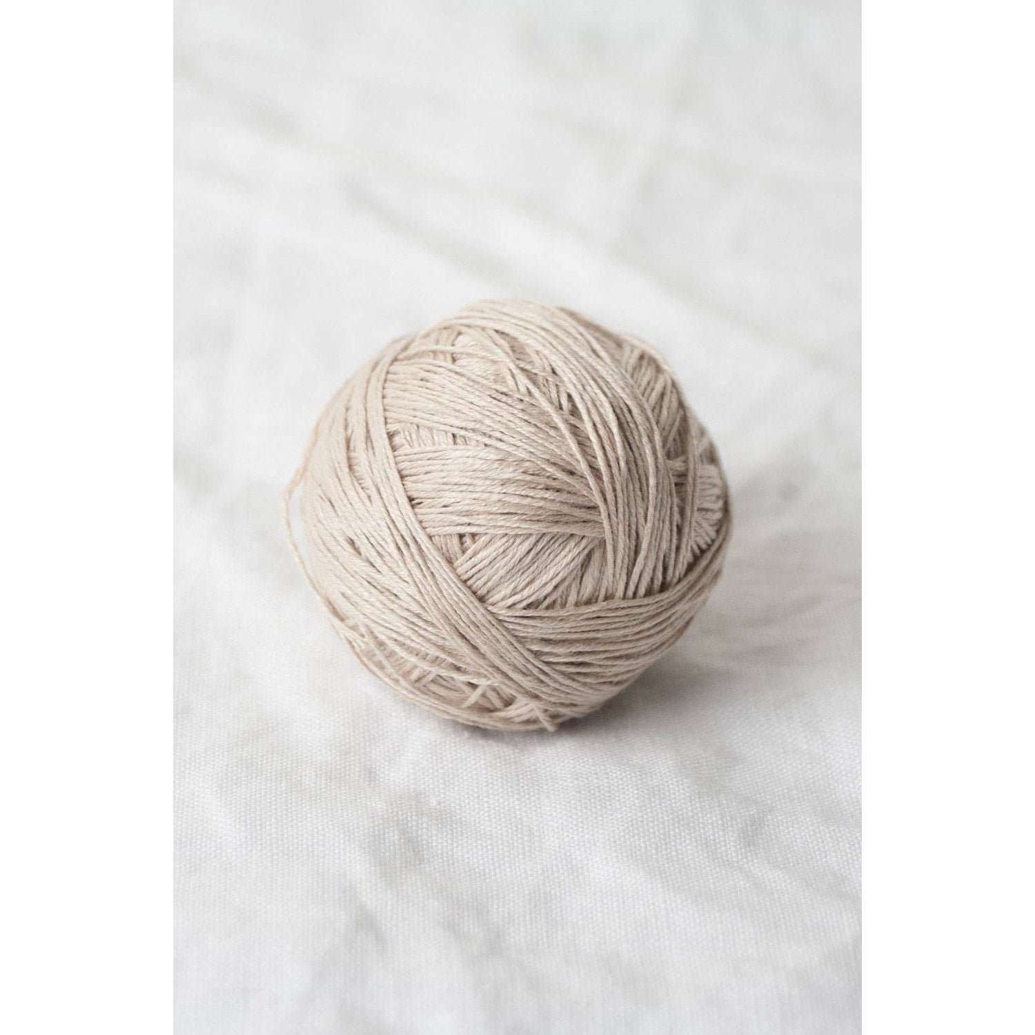 Sparrow organic linen yarn in a light beige ball for eco-friendly knitting projects