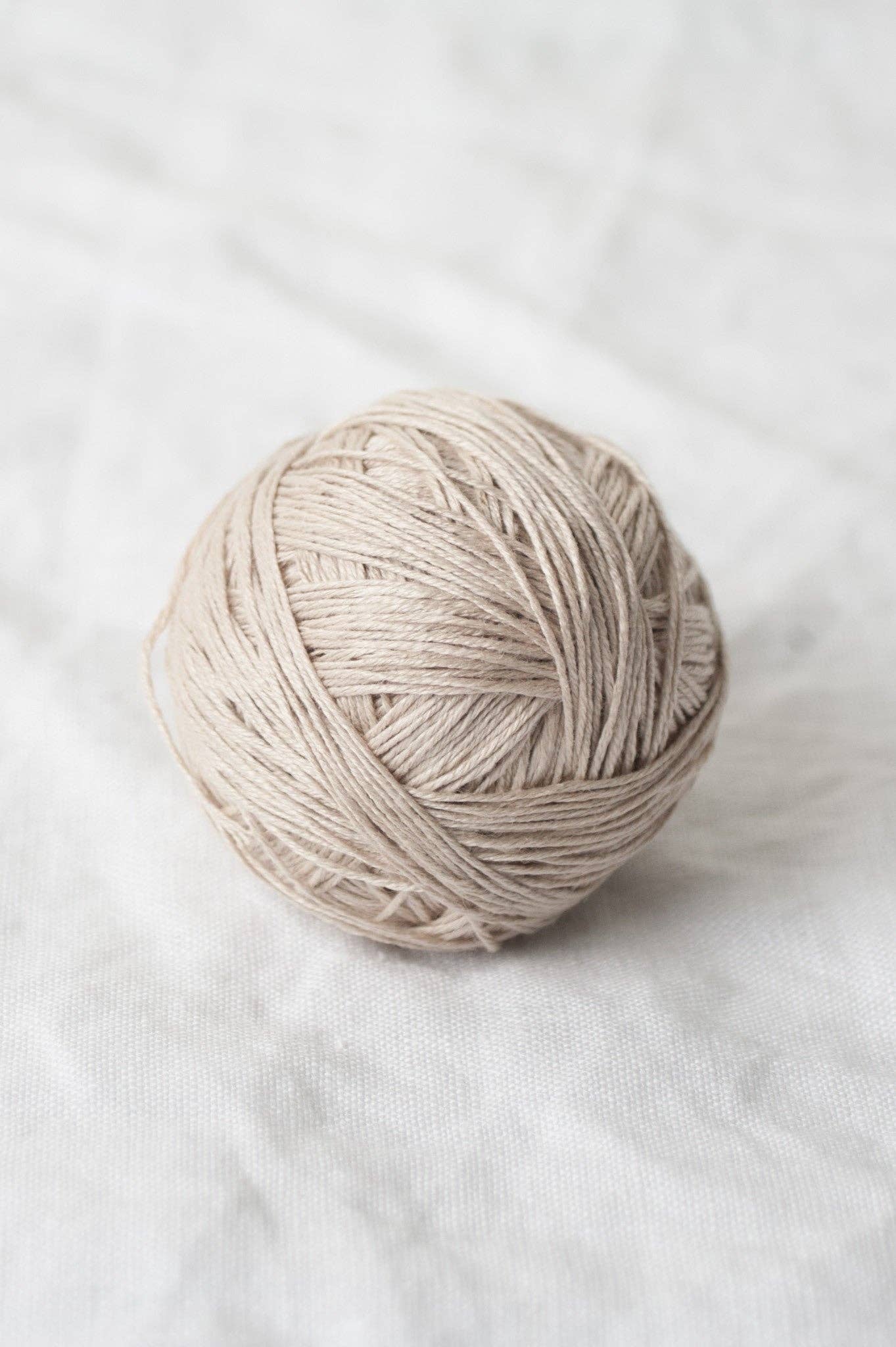 Sparrow organic linen yarn in a light beige ball for eco-friendly knitting projects