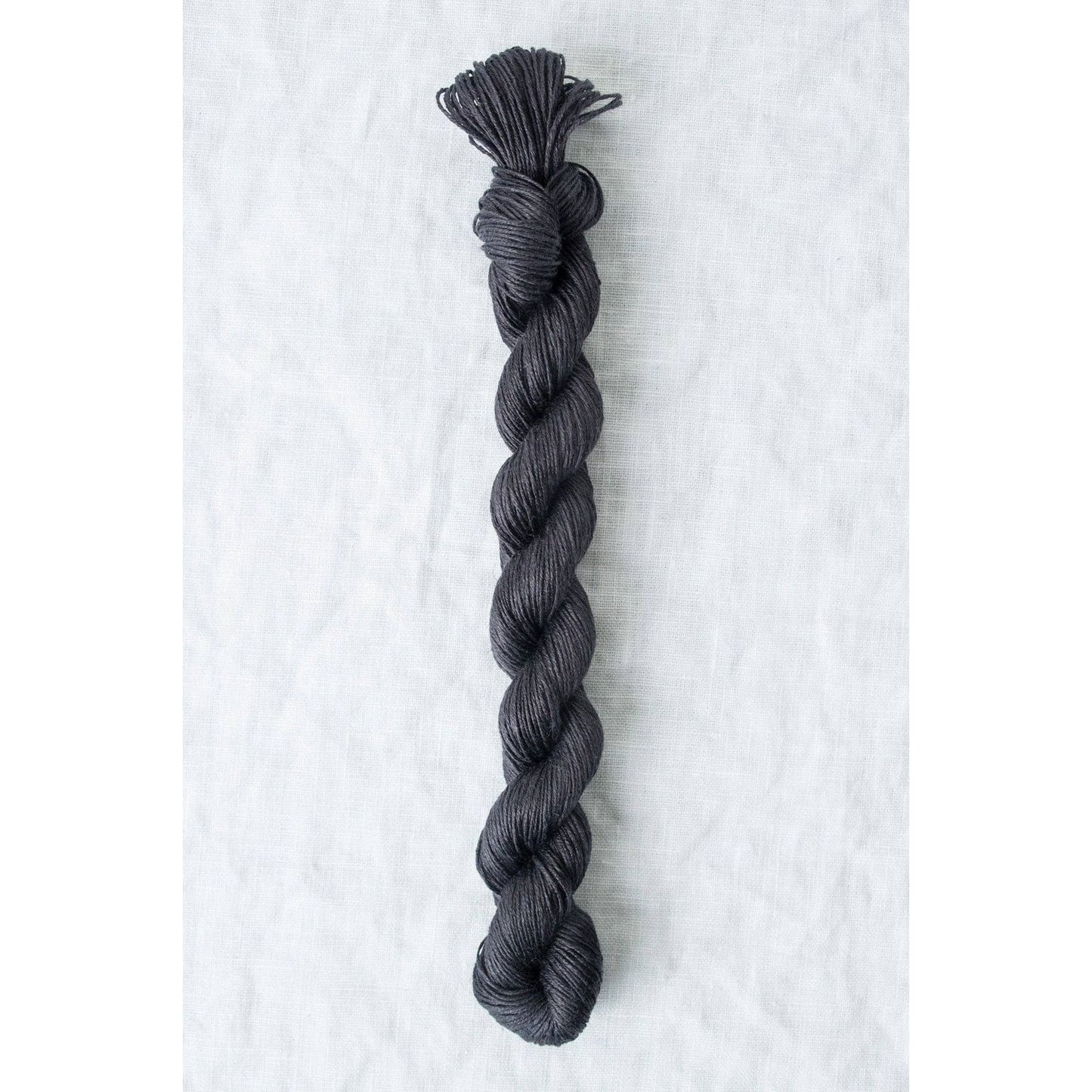 Quince & Co. Sparrow organic linen yarn in a rich dark gray color for knitting and crocheting projects