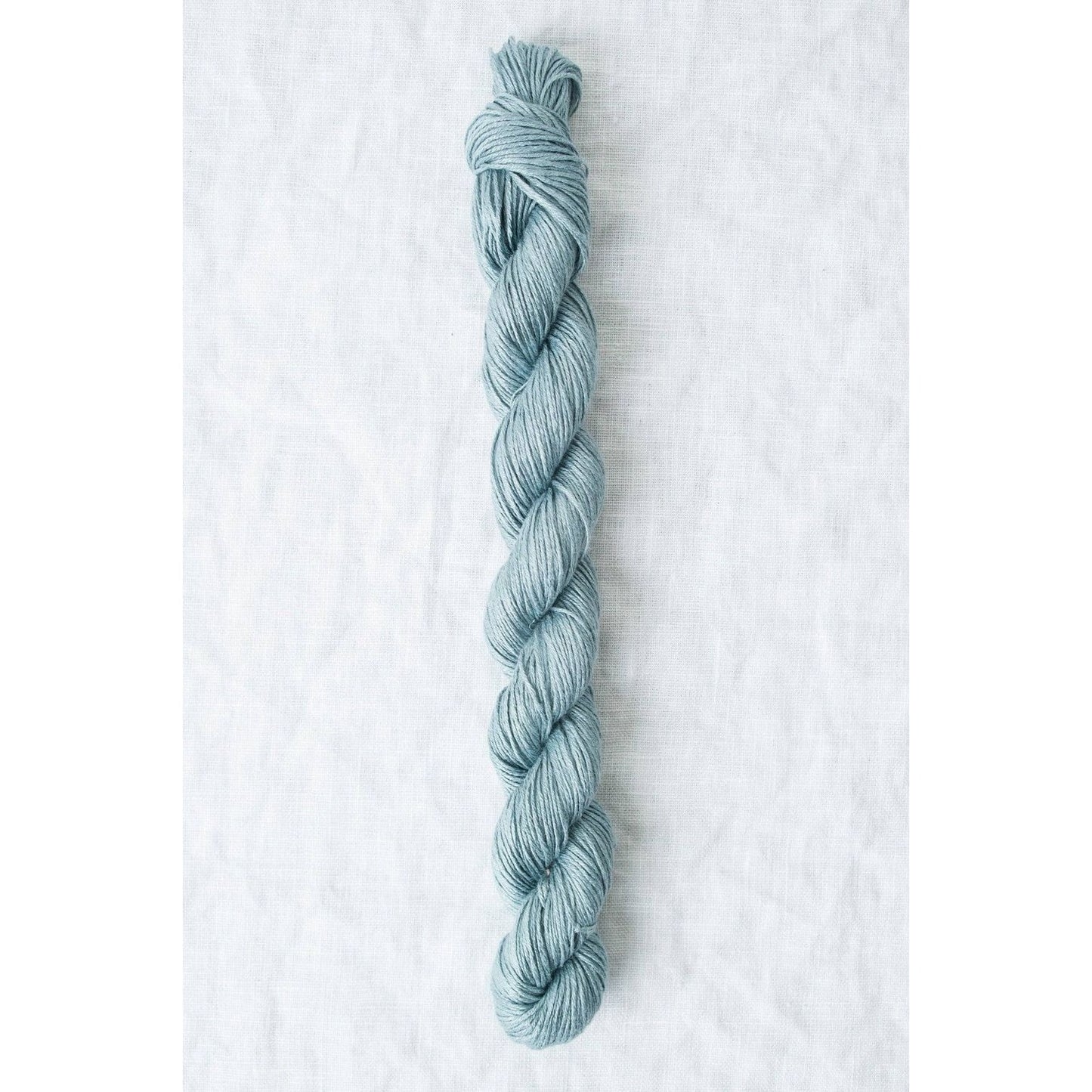Sparrow organic linen yarn in a soothing blue color, perfect for lightweight, breathable projects
