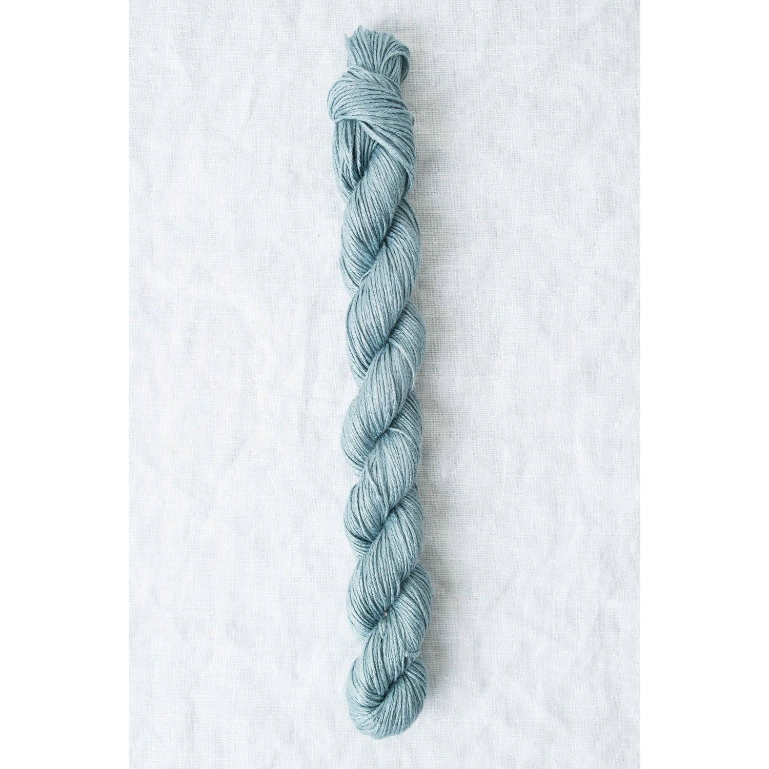 Sparrow organic linen yarn in a soothing blue color, perfect for lightweight, breathable projects