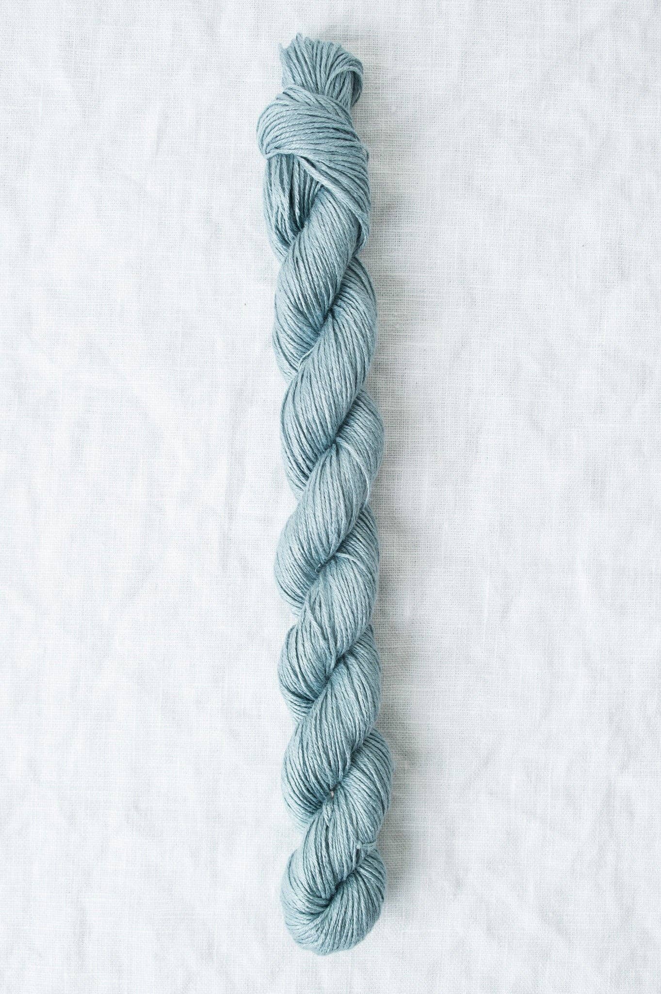 Sparrow organic linen yarn in a soothing blue color, perfect for lightweight, breathable projects