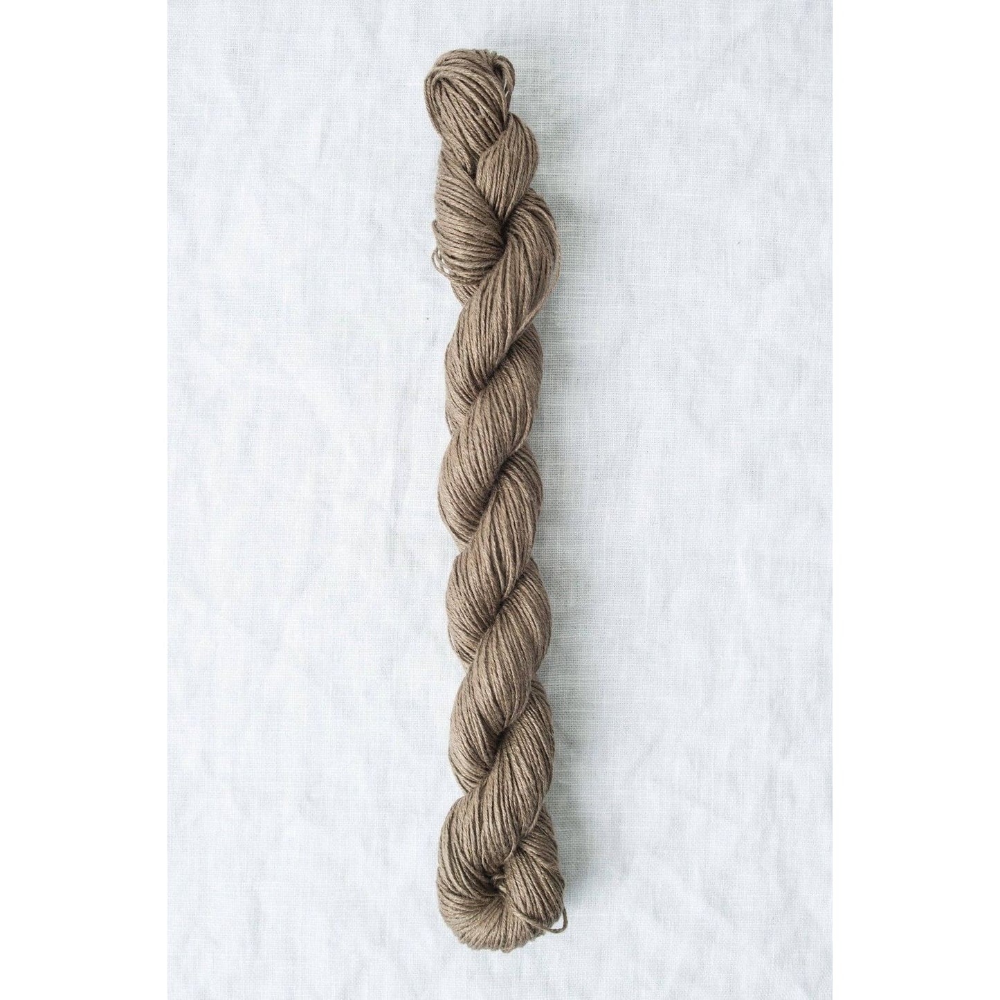 Skein of Quince & Co. Sparrow organic linen yarn in natural brown color for knitting projects