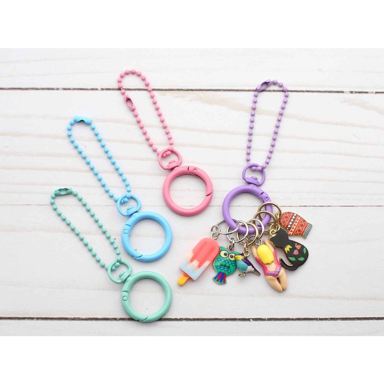 Colorful stitch markers for crochet featuring fun charm designs on each marker