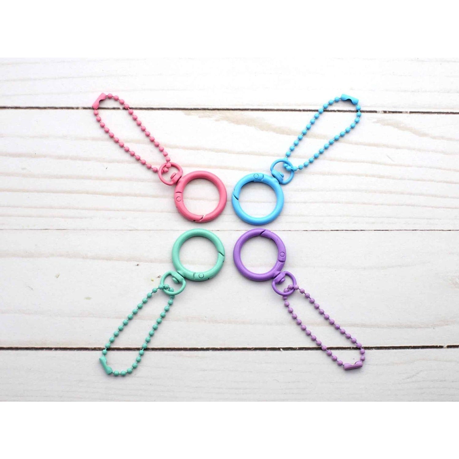 Colorful stitch markers for crochet in pink, blue, green, and purple, perfect for organizing projects