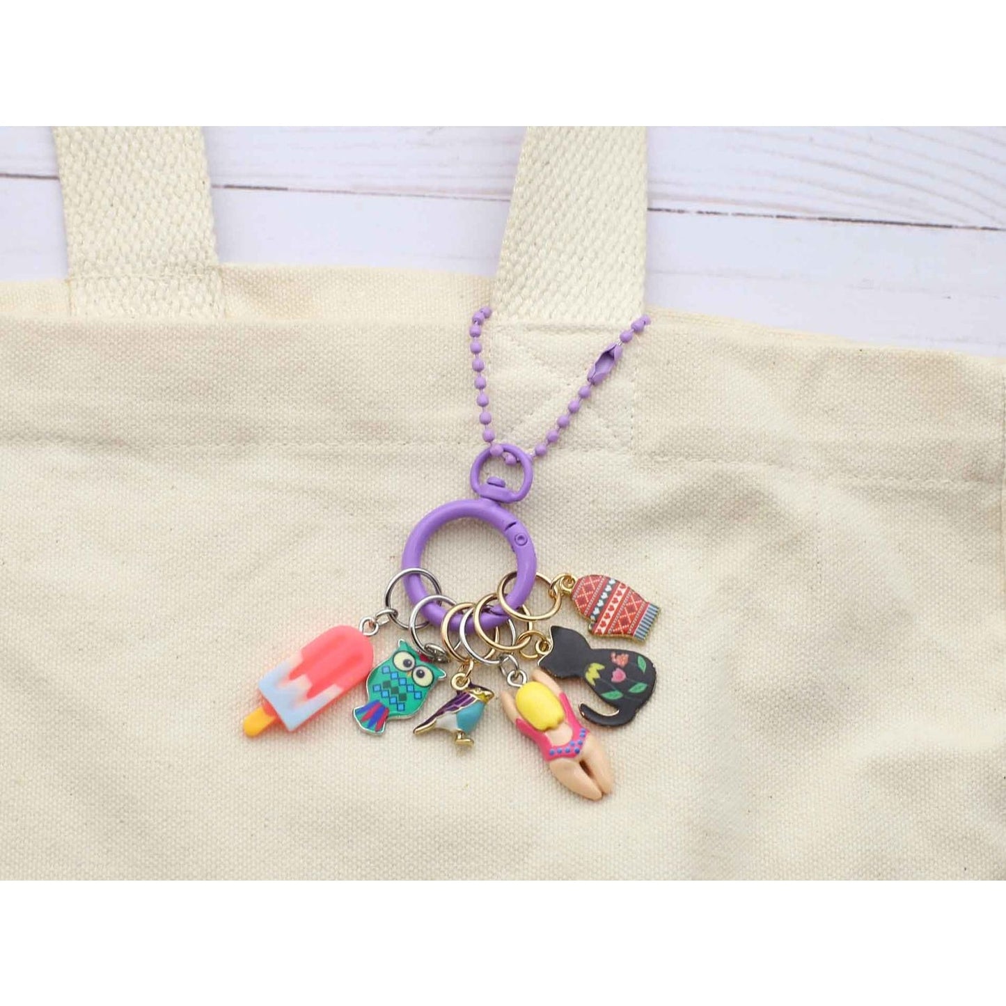 Colorful stitch marker for crochet featuring fun charms like a popsicle and a swimming girl