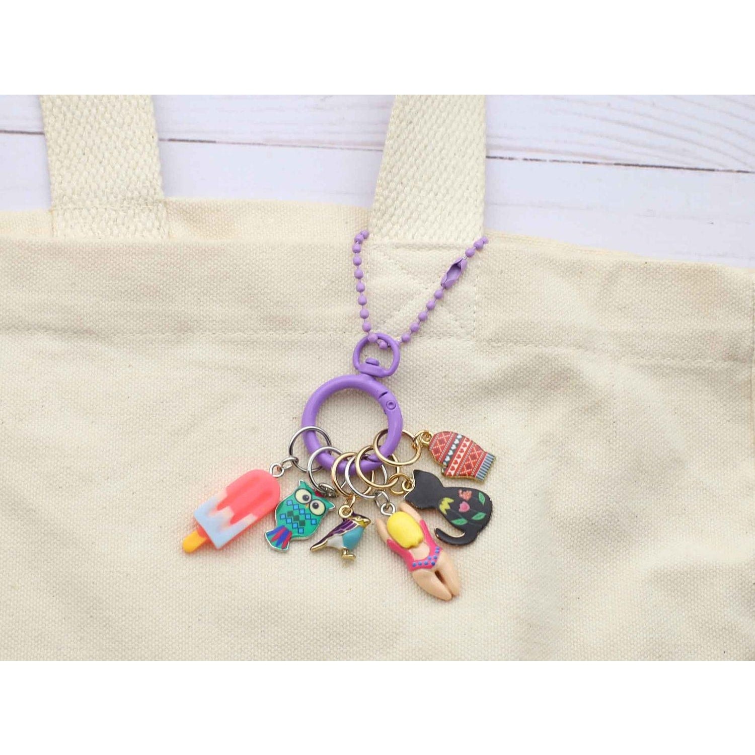 Colorful stitch marker for crochet featuring fun charms like a popsicle and a swimming girl