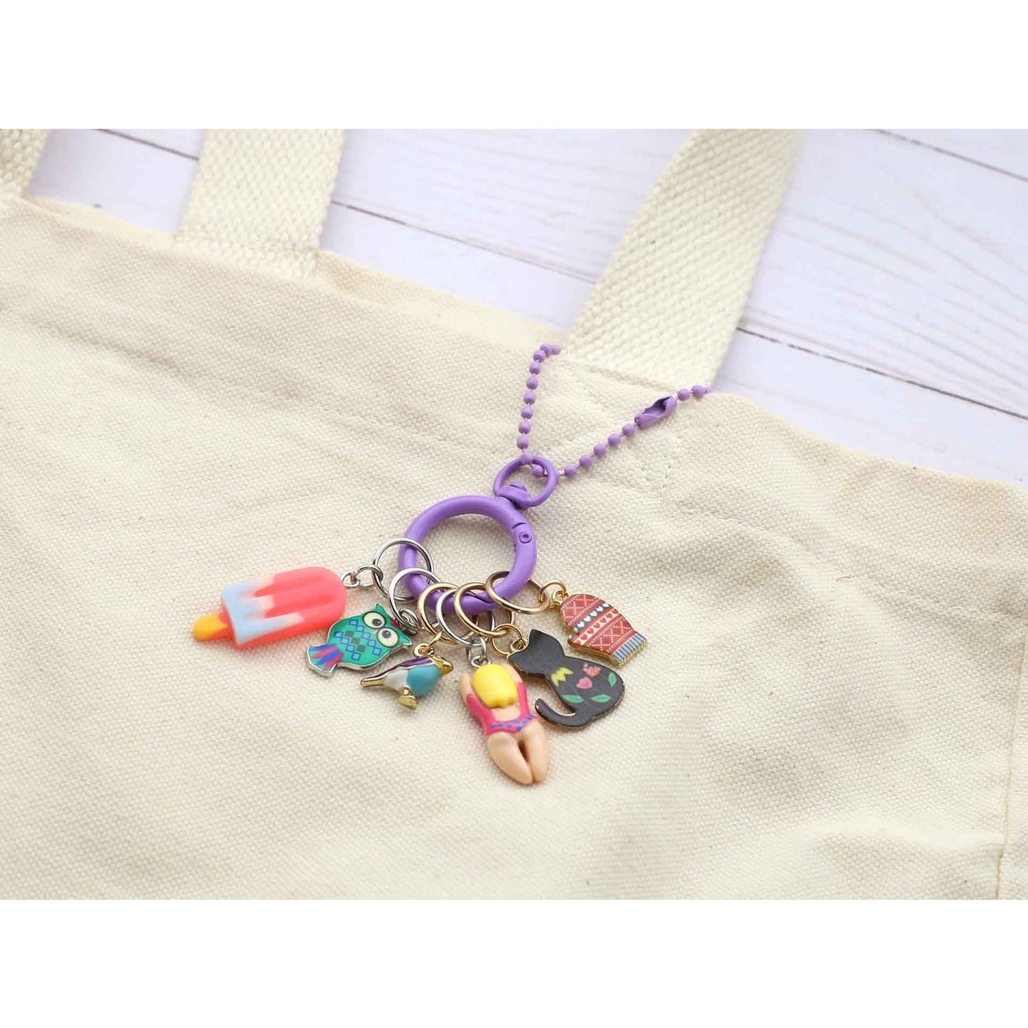 Colorful stitch marker for crochet with charming charms attached for creative knitting projects