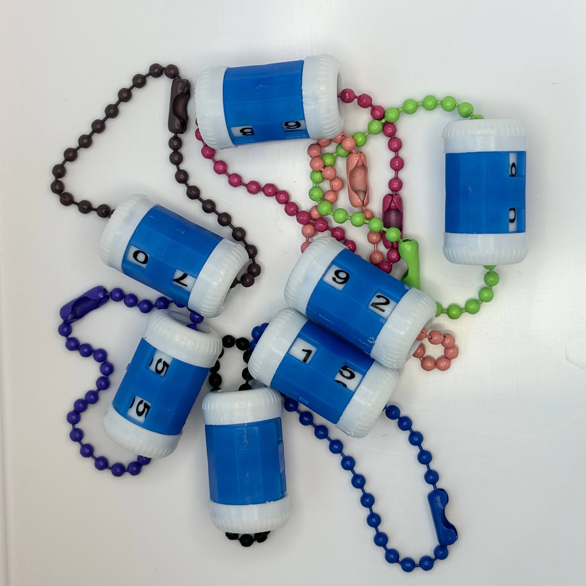 Colorful stitch markers for crocheting with numbered containers and beads for easy tracking
