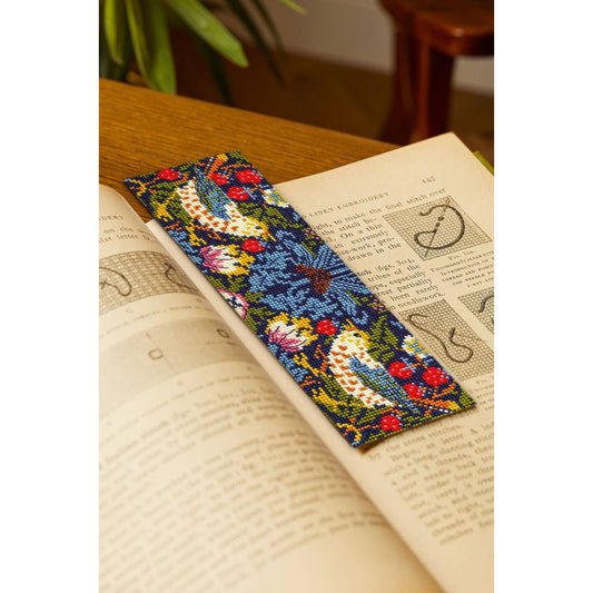 Colorful DMC cross stitch bookmark featuring birds and floral designs with detailed stitching