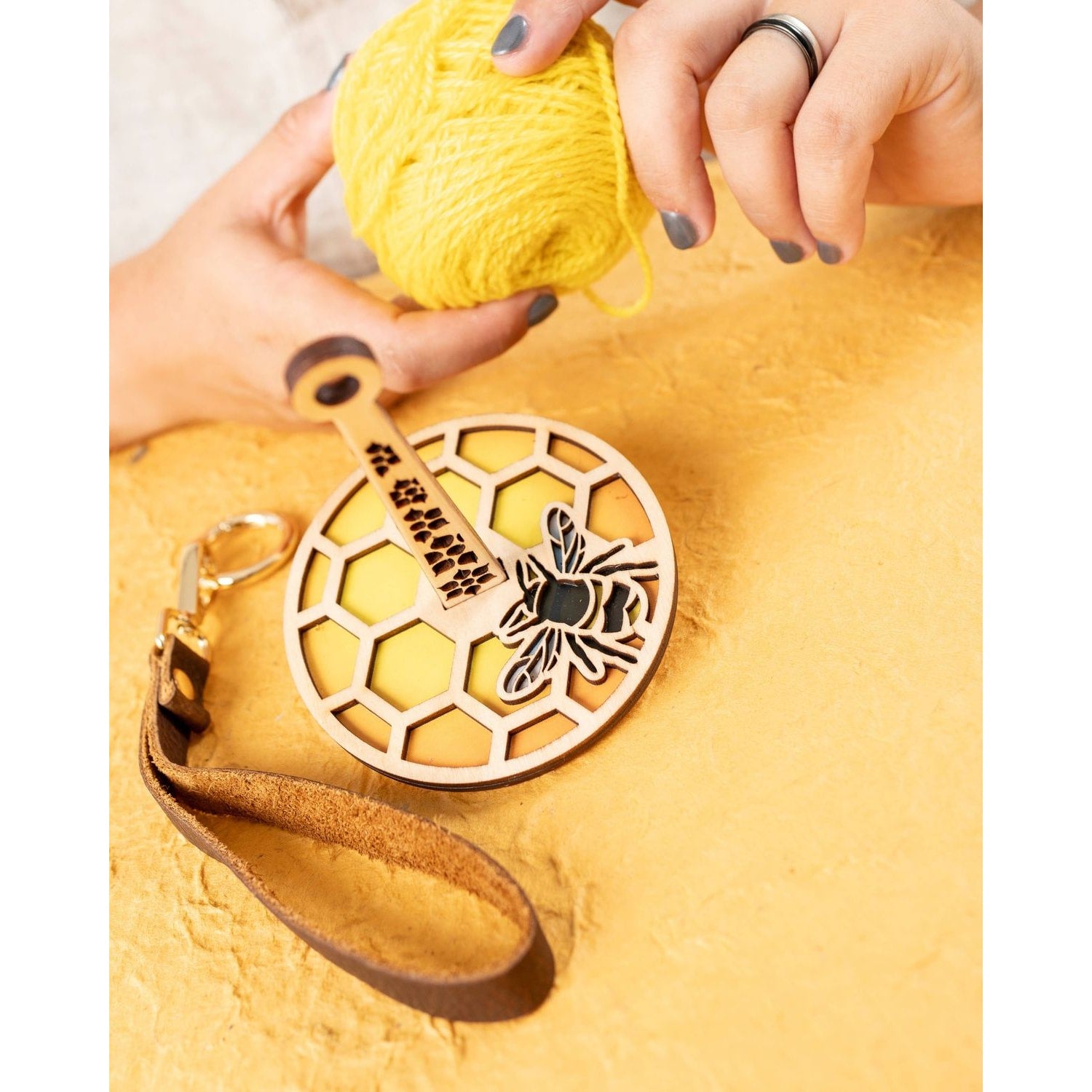 Lemonwood wooden bee knitting accessory honeycomb yarn holder with leather wrist strap for easy knitting