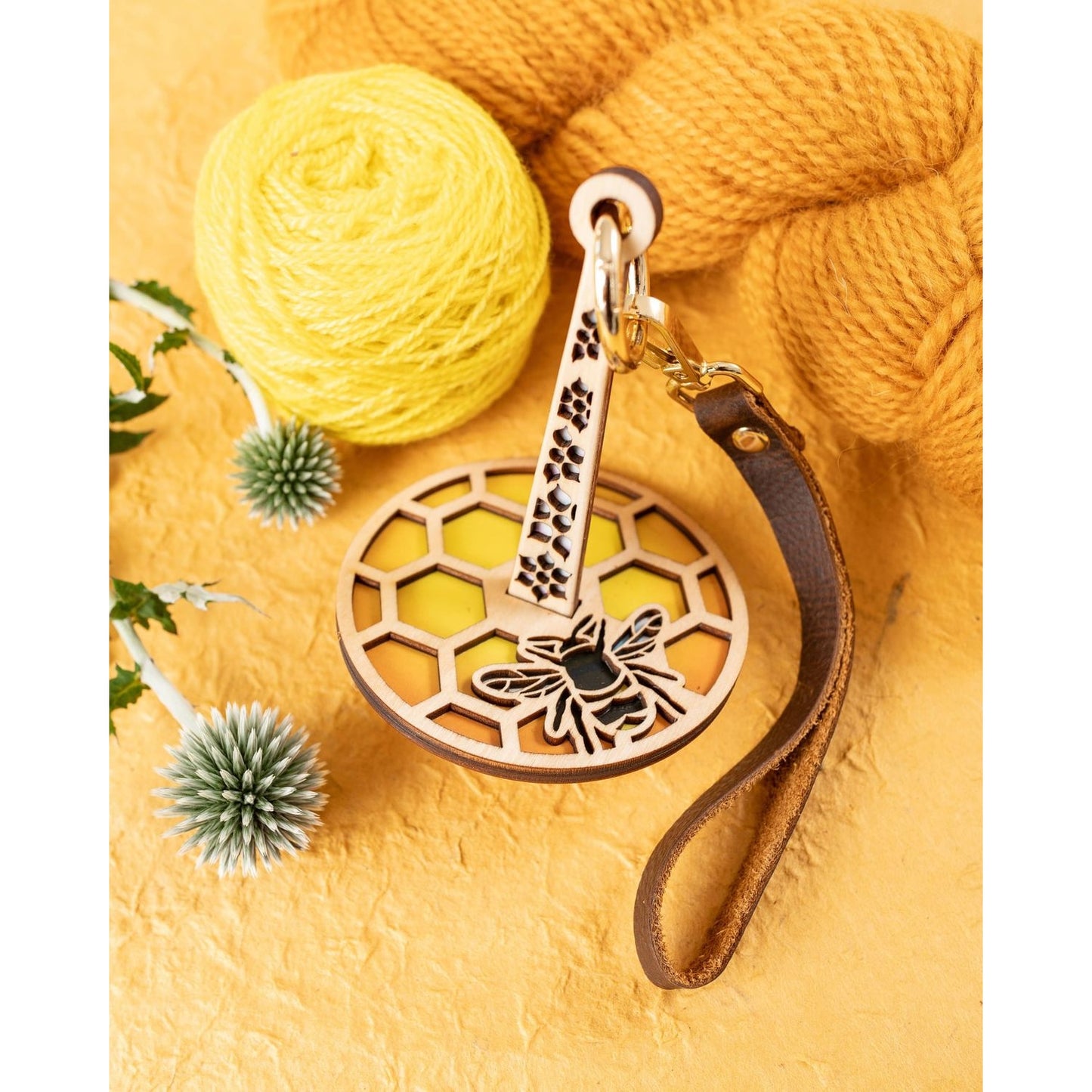 Lemonwood wooden bee knitting accessory keychain with honeycomb detail leather strap and yellow yarn