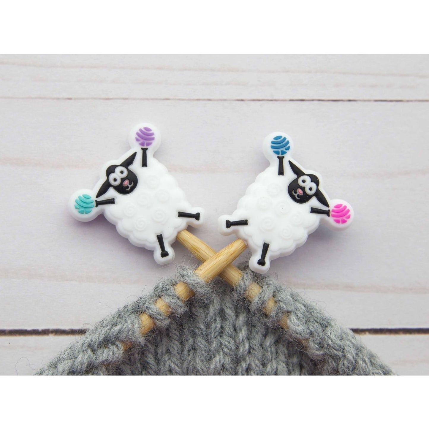 Fox and Pine Stitches sheep stitch markers on wooden knitting needles with gray yarn for knitters