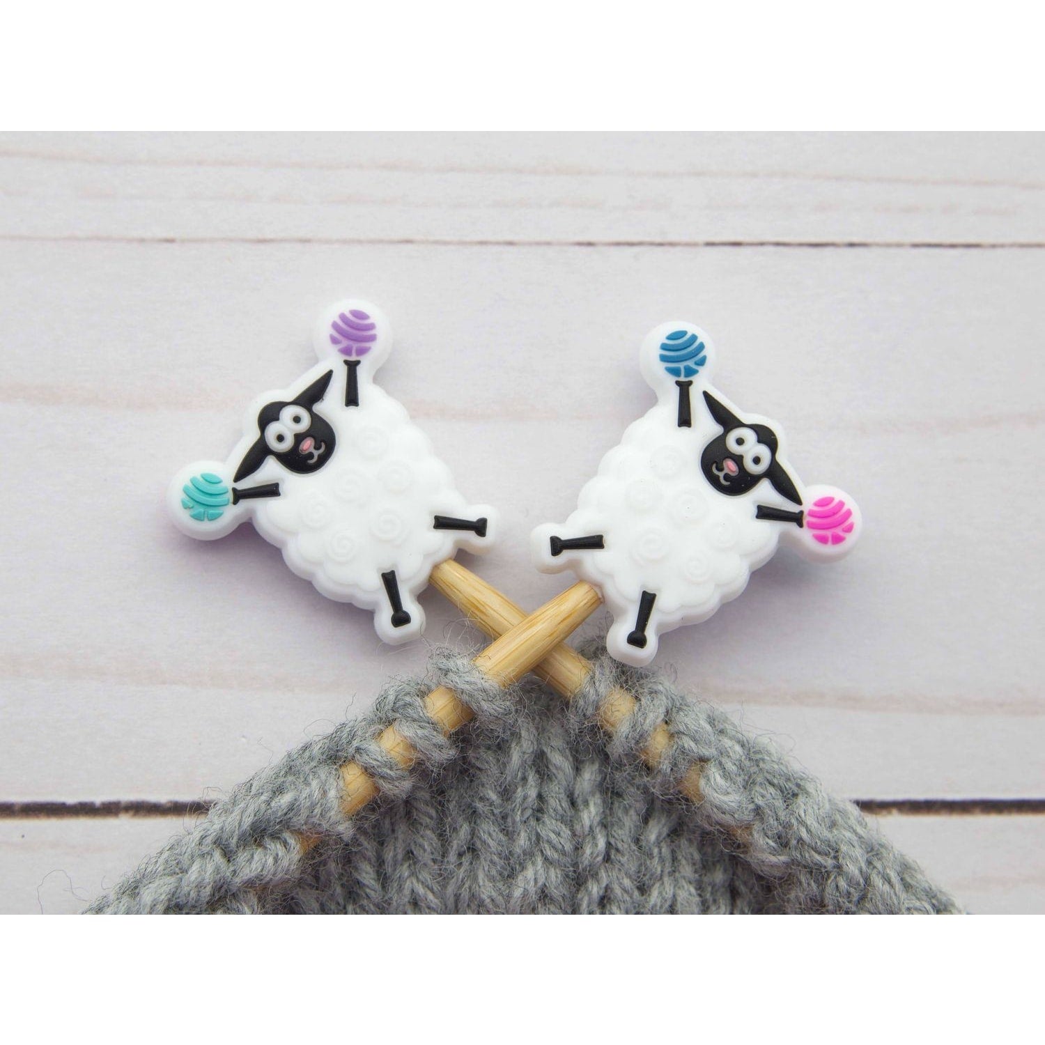 Fox and Pine Stitches sheep stitch markers on wooden knitting needles with gray yarn for knitters