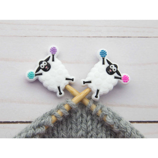 Fox and Pine Stitches sheep stitch markers on wooden knitting needles with gray yarn for knitters