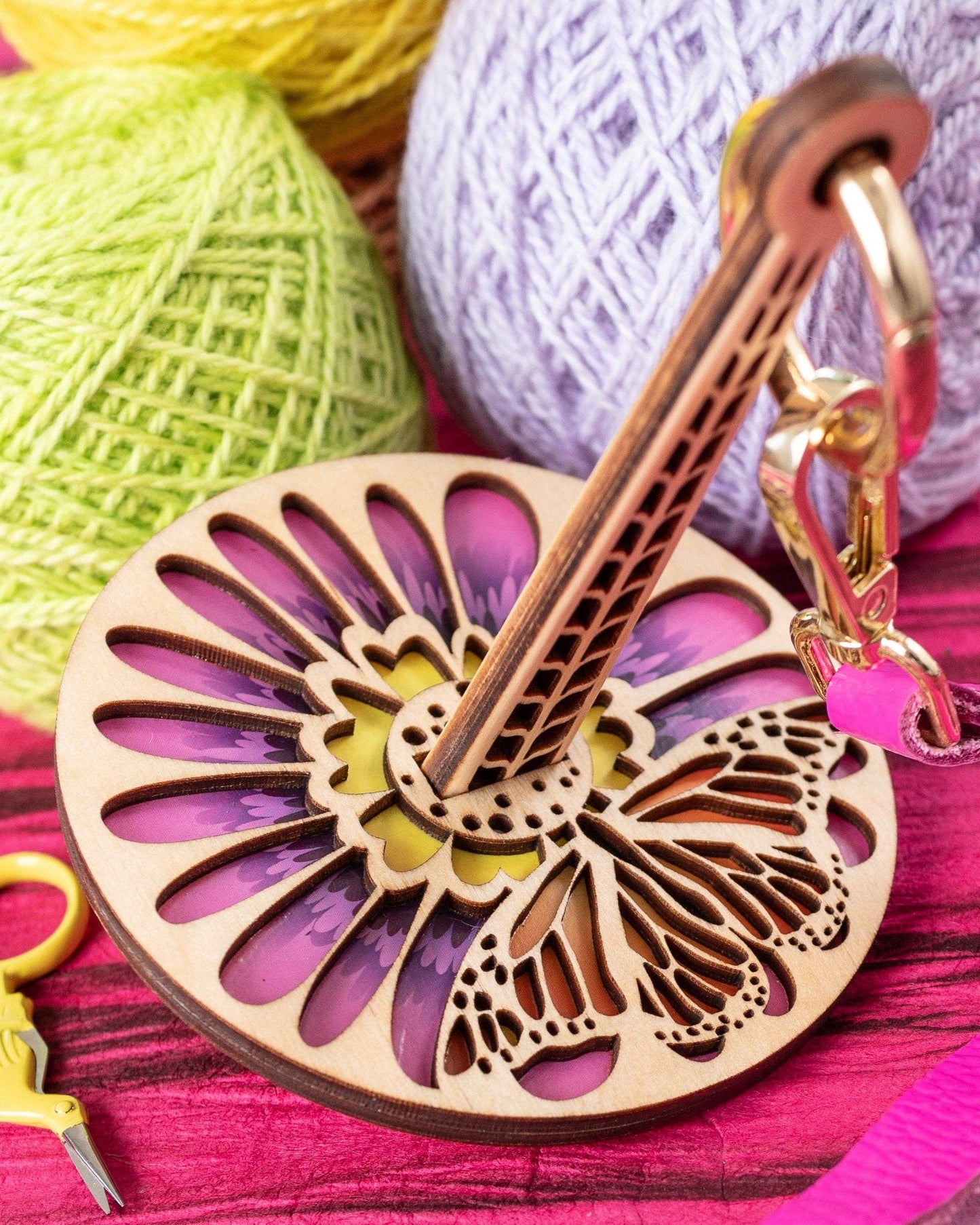 lemonwood monarchana yarn accessory wooden butterfly yarn holder with floral cutouts and colorful yarn balls